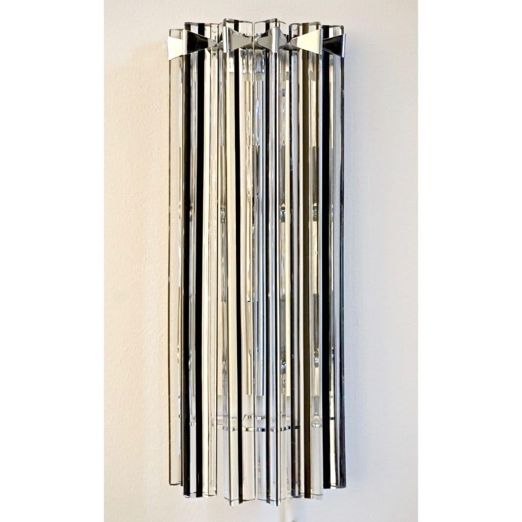 Very sleek Venetian pair of wall lights with organic Minimalist design, consisting of six spectacular straight crystal clear Murano glass rods of triangular section with amazing concave sides, crafted with an encased black glass thread in the core