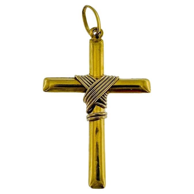 The cross features a classic cross shape, symbolizing Christianity and faith. However, it is designed with a contemporary twist.  It is crafted from high-quality yellow gold, which gives it a luxurious and timeless appearance. 
The most distinctive