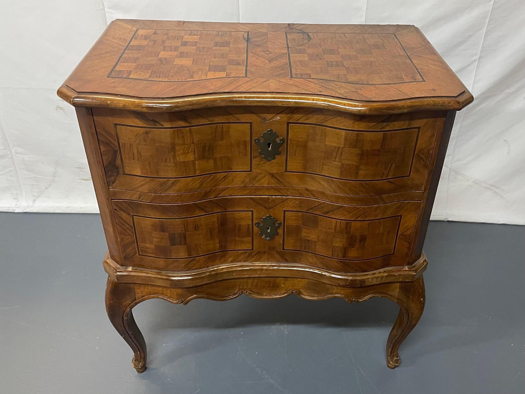 Italian Continental 19th c. two drawer chest, commode, nightstand, parquetry.
 
An Italian Continental 19th century two drawer chest, commode or night table. The case front is characterized by an elegant serpentine contouring and both front an top