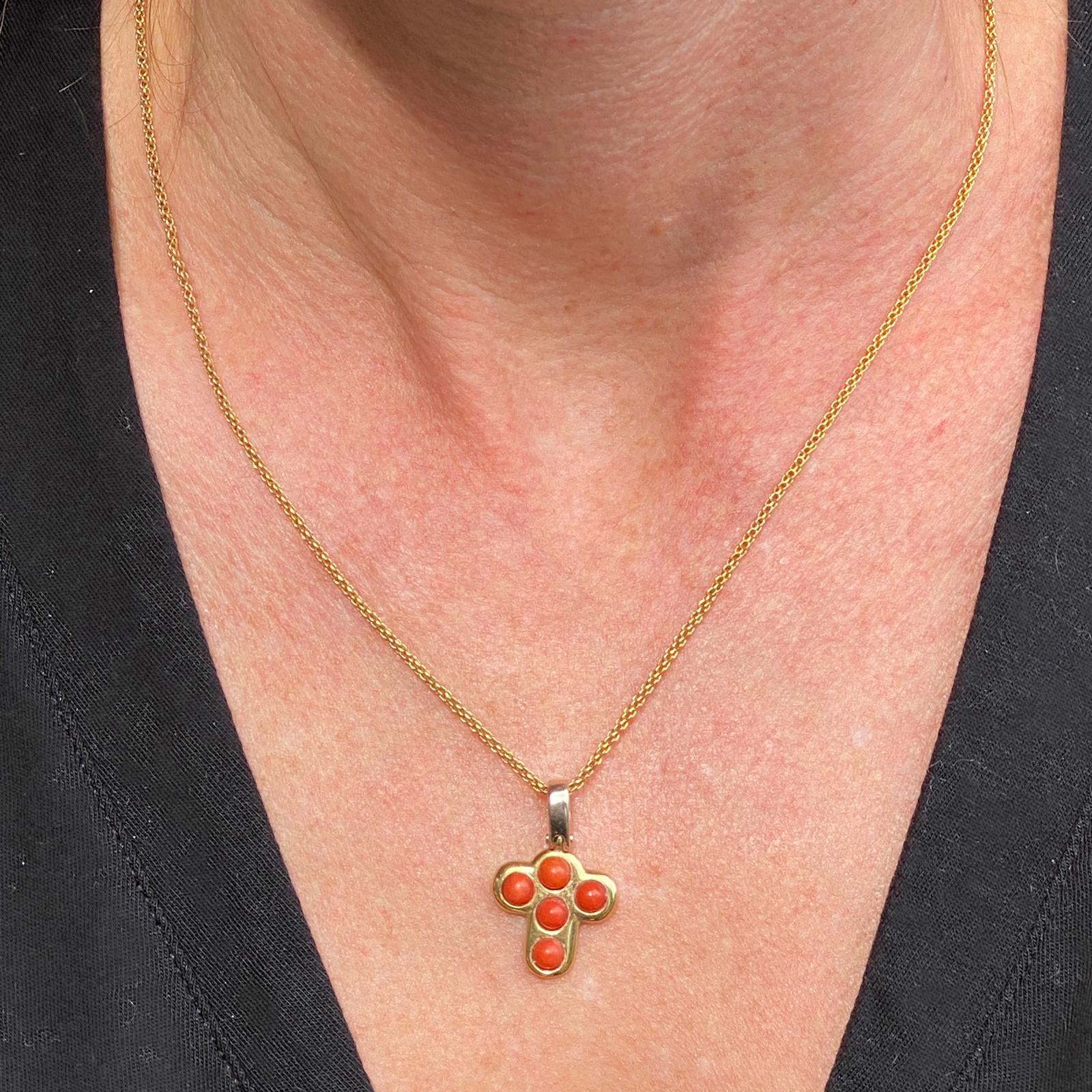 Fabulous vintage coral cross pendant and necklace crafted in 18 karat yellow gold ( the baile of the pendant is 18 karat white gold). The pendant featues 5 bezel set coral gemstones, and measures .60 x 1.00 inches. The 18k gold chain measures 16