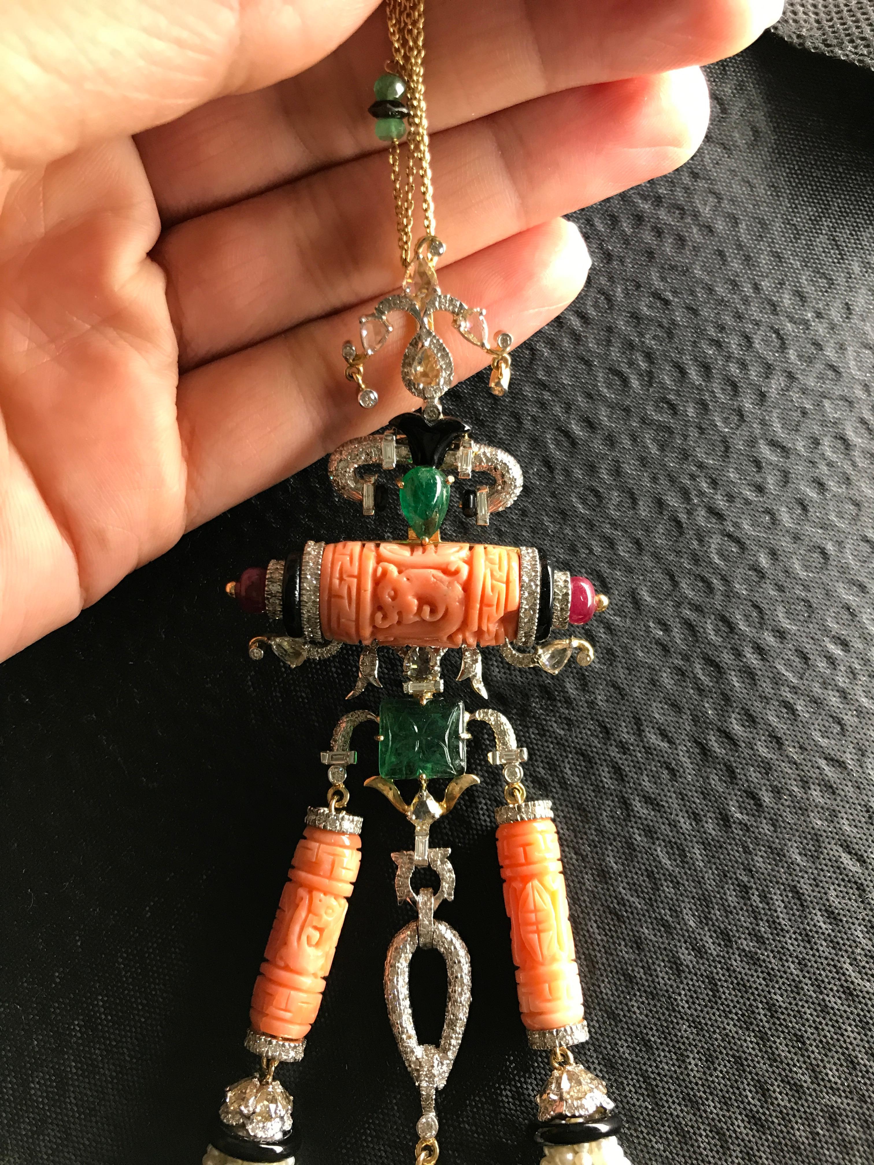 An art-deco looking, gorgeous Italian Coral and South Sea Pearl tassle necklace, with Zambian Emerald and Ruby and Diamonds. This tassle is 6.5inches long, and the chain (with emeralds) is 24inches long.

Details:
Coral: 37.01 Ct
Emerald: 8.15