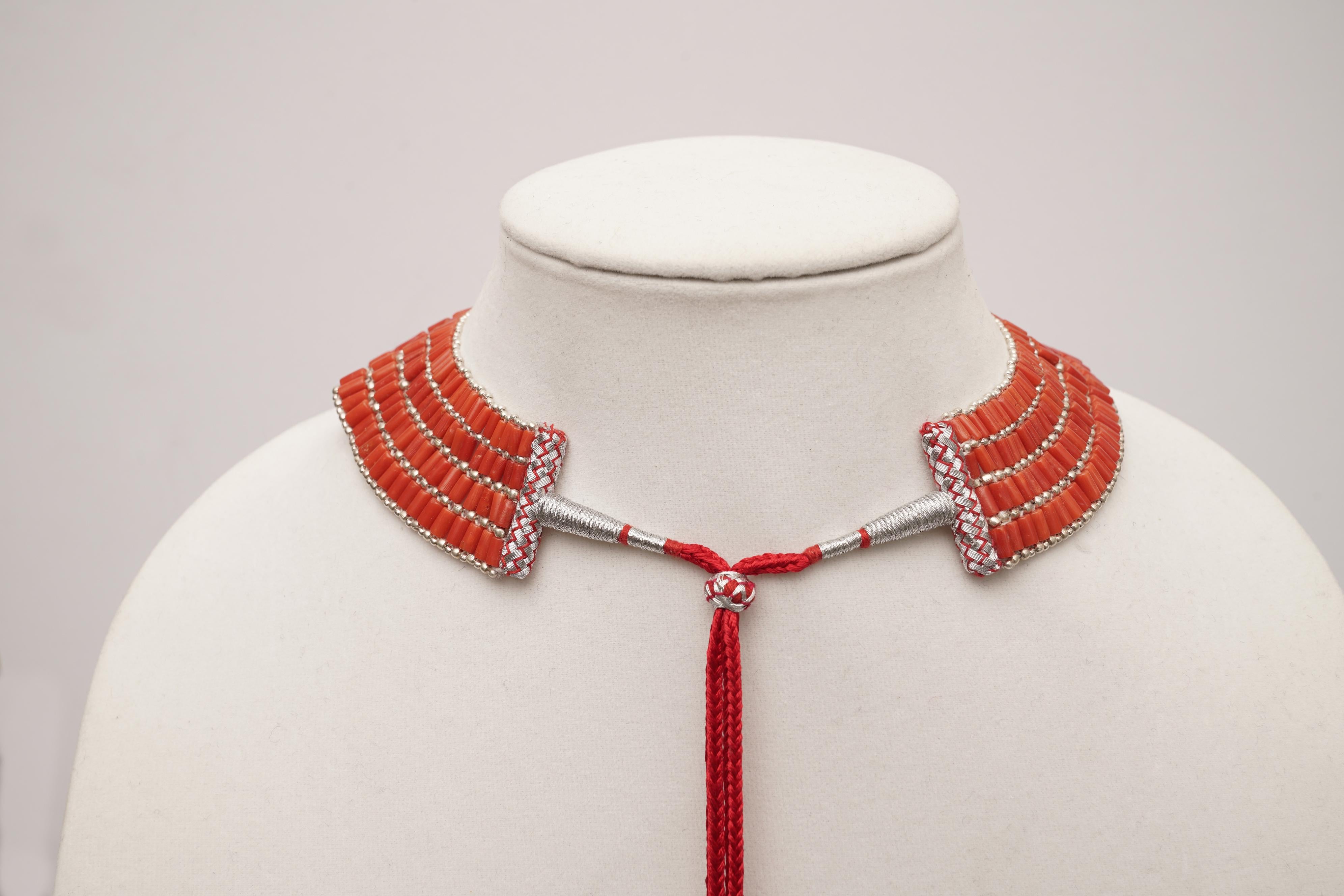 Dramatic Italian coral and sterling silver choker necklace, slightly graduated.  It is adjustable at the back with a bolero-type closure with a cluster of coral that will drape down the  back.  The smallest setting is 12 inches.  A great piece on an