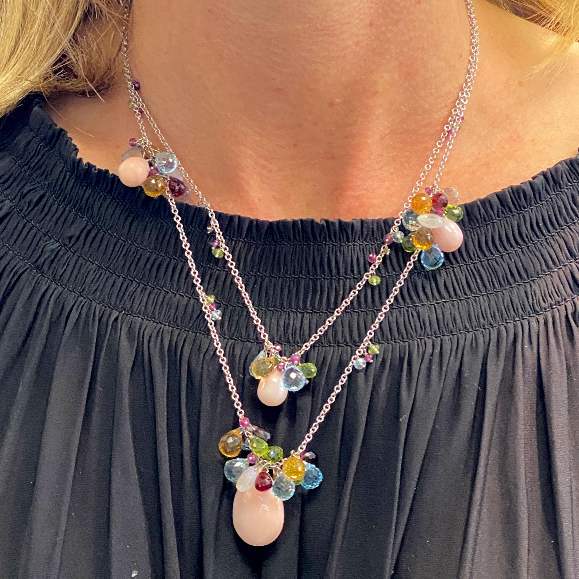 Colorful designer necklace by Italian designer Zoccai. The two strand necklace features multi-color briolette cut gemstones and large coral drops. The necklace is fashioned in 18 karat white gold and the shorter strand measures 16 inches in length. 