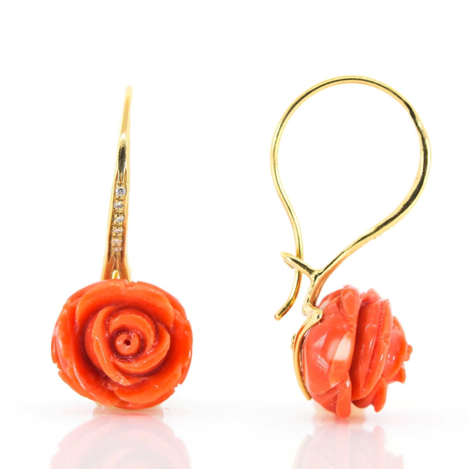 These beautiful drop earrings feature two dimensional hand carved pink Coral flowers.  Place at the bottom of large 18KT yellow gold hoops, they gently sway about one inch from the ear.  Each set with a line of subtly sparkly diamonds all weigh