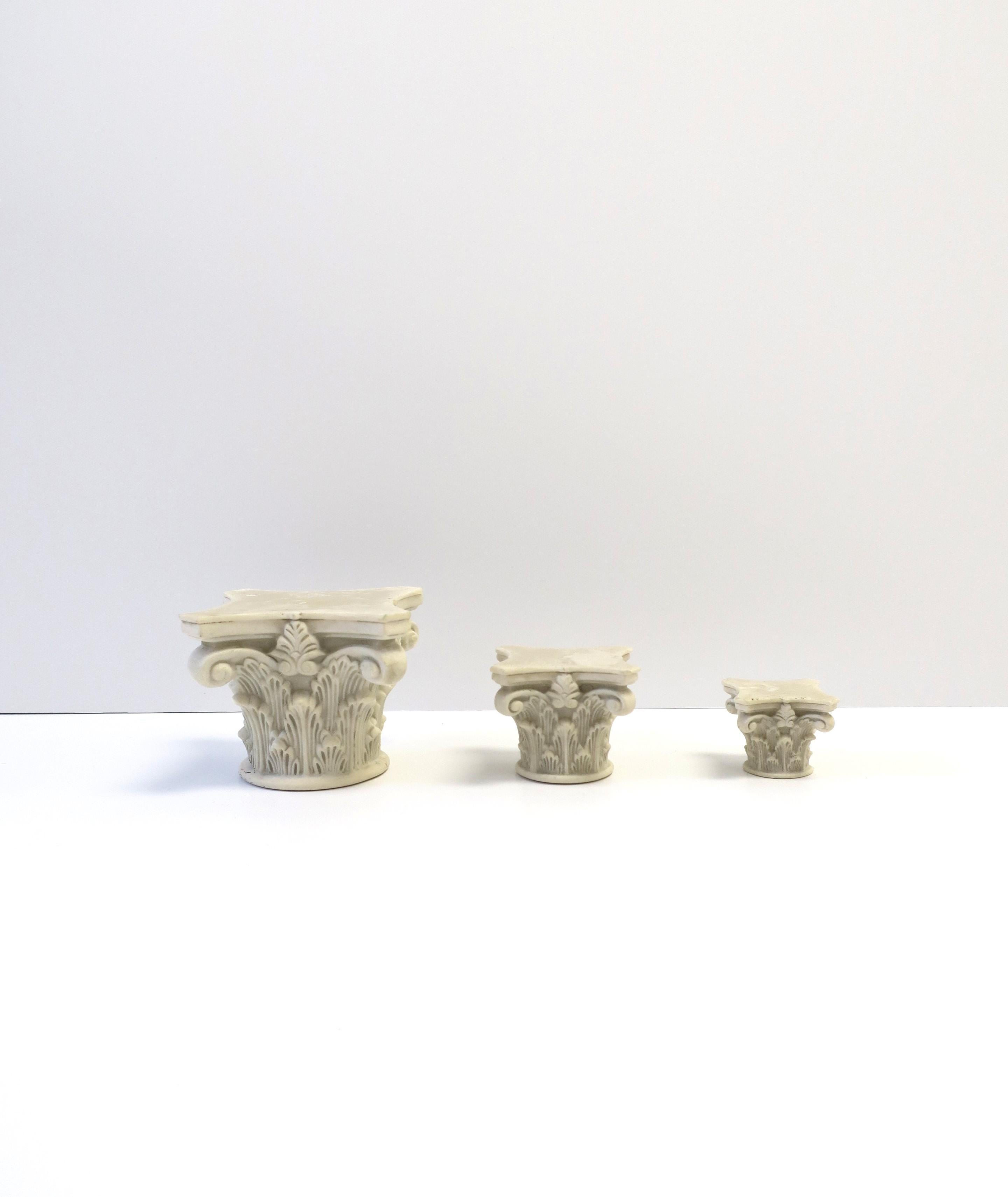 A set of three (3) Italian Corinthian column pillar capitol decorative objects in the Neoclassical style, circa mid-20th century, Italy. A great set of objects for a table, desk, office, library, etc. 

Dimensions: 
Large: 3.25