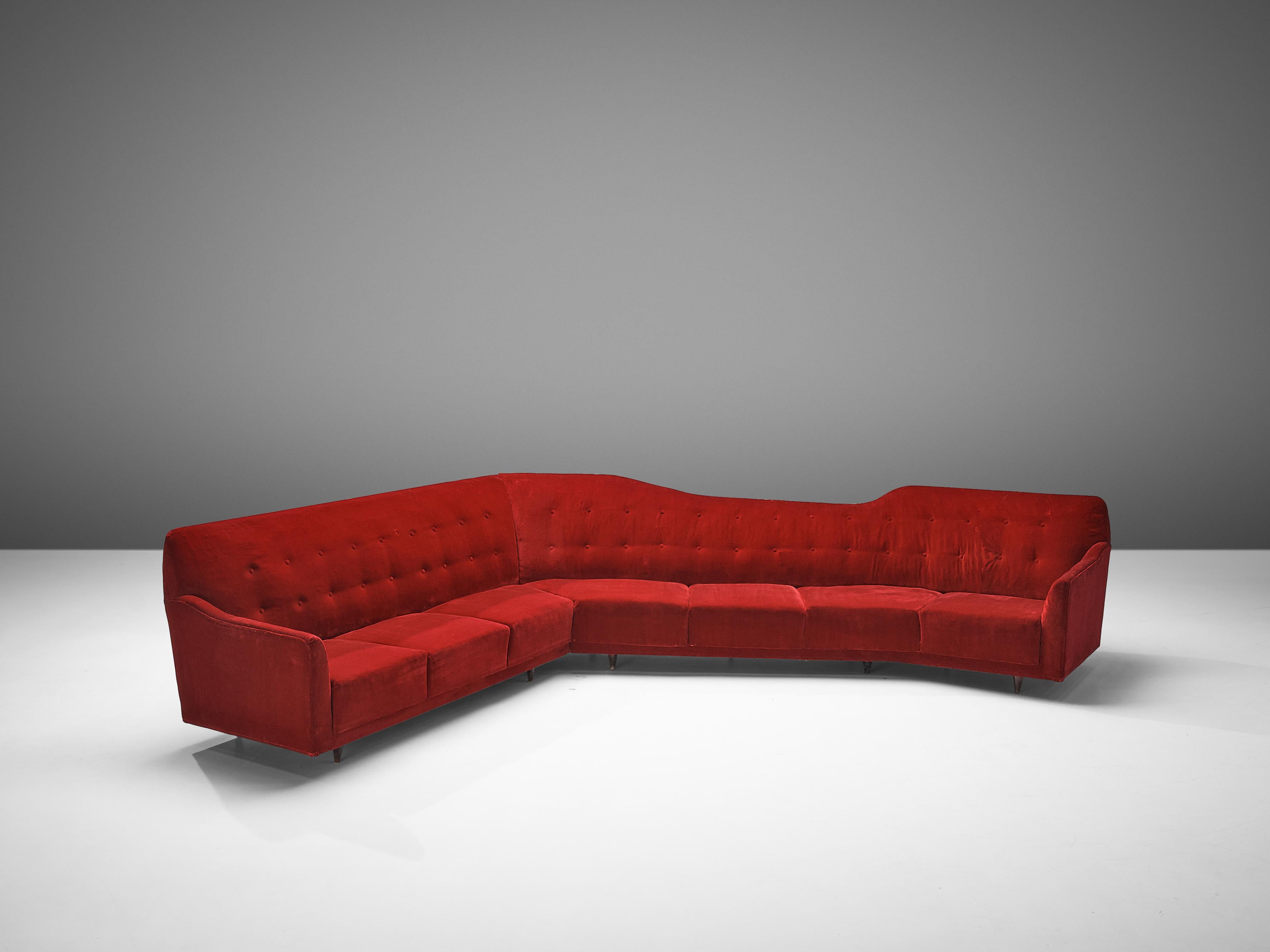 Sofa, red velvet upholstery, Italy, 1950s

Beautiful and very spacious sofa made in Italy in the 1950s. This corner sofa is an eye-catching piece that has all the characteristics of mid modern design. Not only does the sofa have an interesting