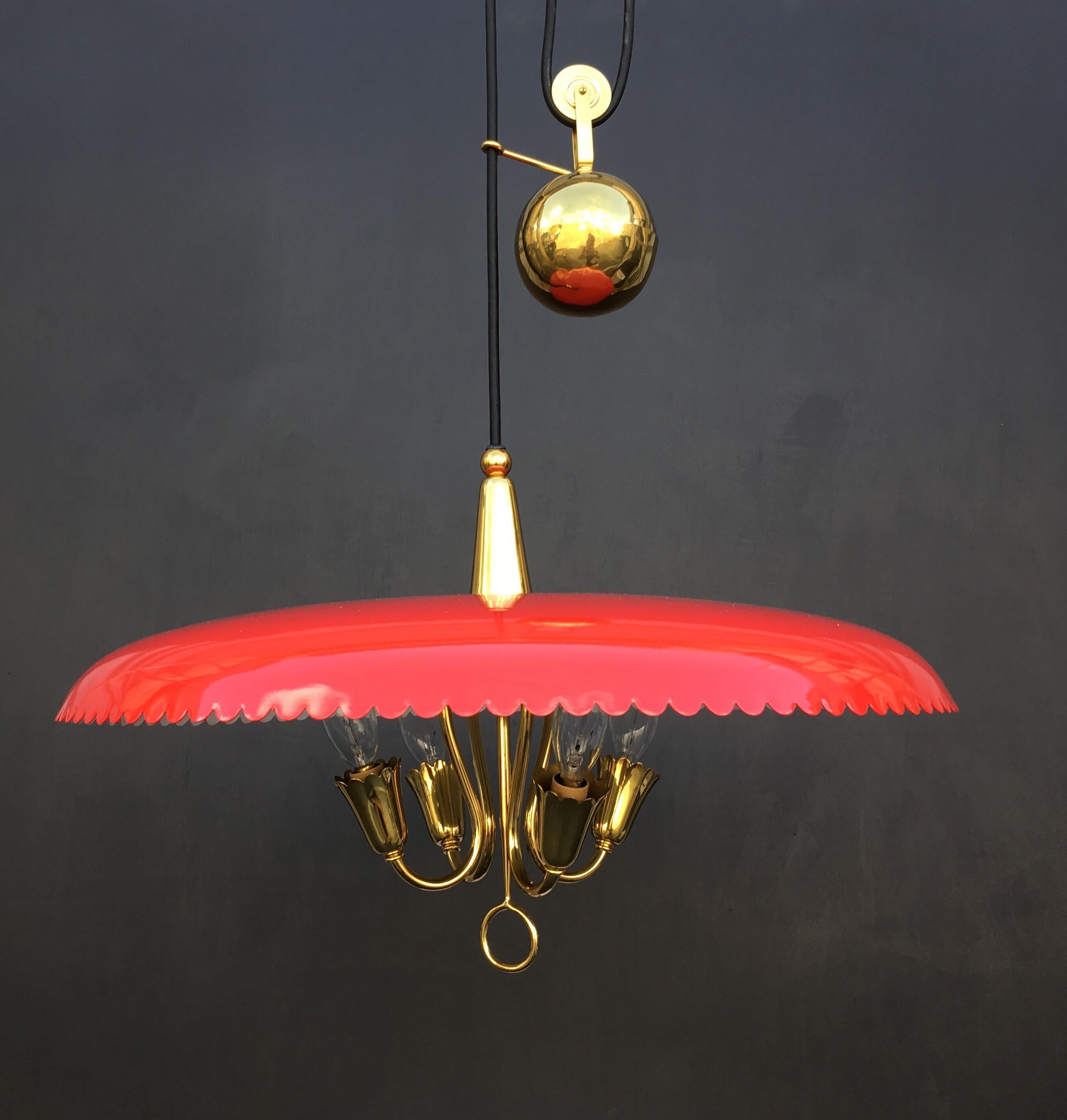 A counter weight chandelier in brass and red lacquered shade. The overall length is adjustable 43”-64”. Made in Italy, circa 1950s. Very much in the style of Paavo Tynell.
 