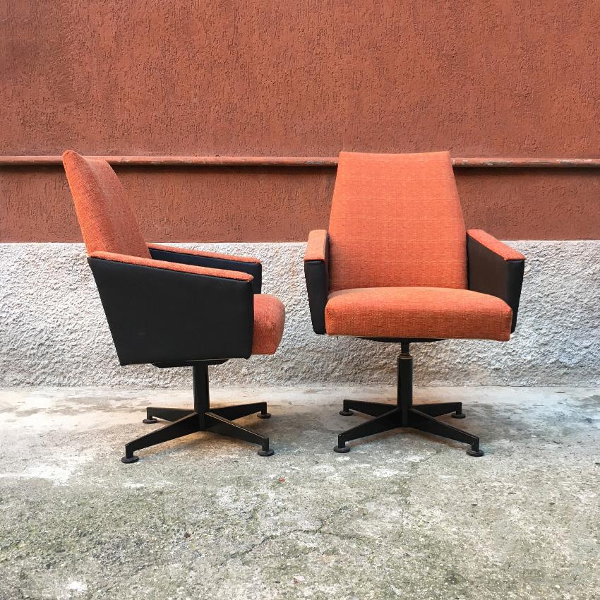 Italian couple of orange fabric, sky and metal swivel chairs, 1960s. Couple of swivel armchairs, equipped with armrests. Structure in black enameled metal; seat, back and armrests in its original orange fabric; black sky details on the armrests.