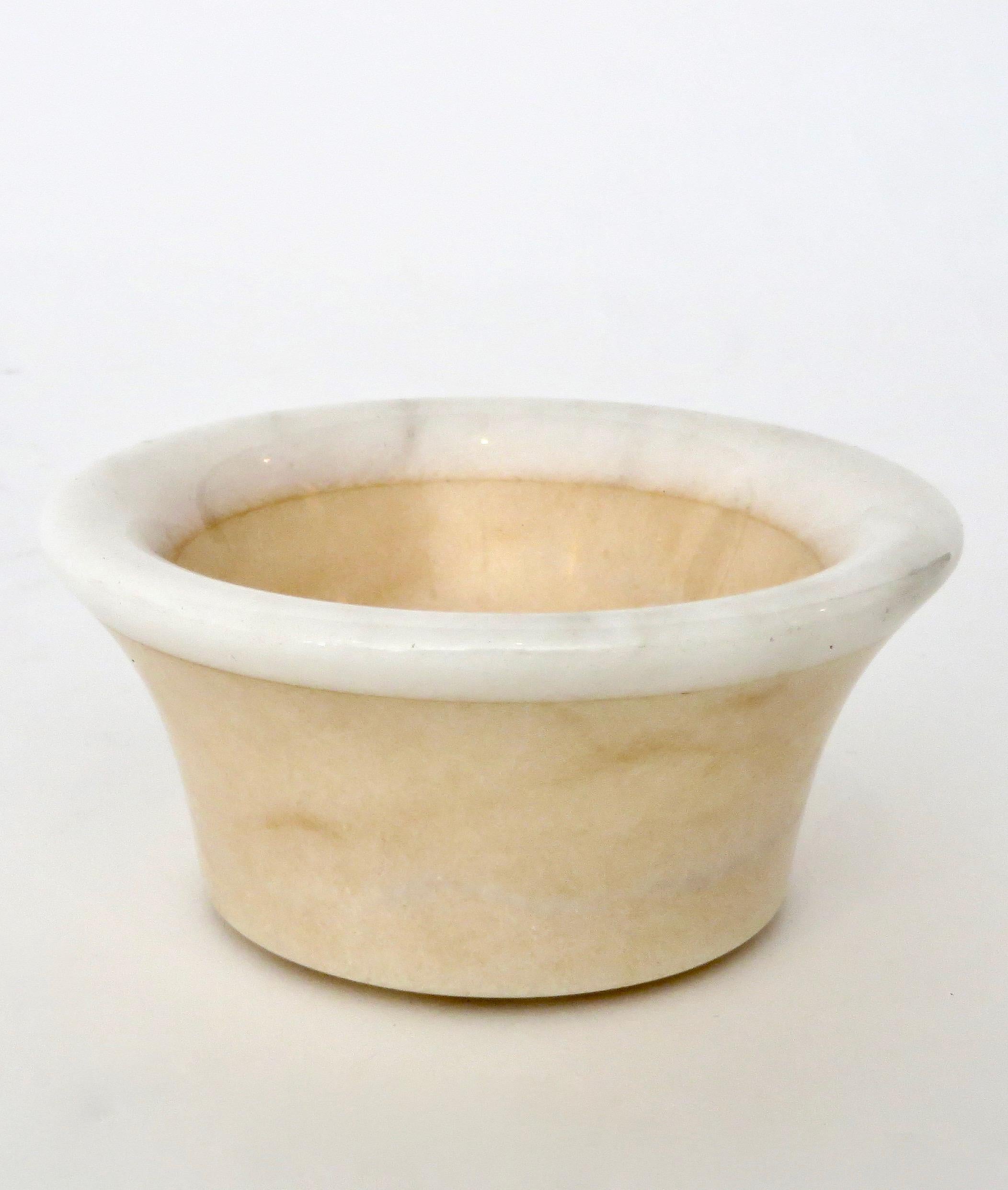 A cream polished marble bowl or dish or vide poche for the dresser, desk or any other use. 
This bowl has a lighter creamy white polished edge.
