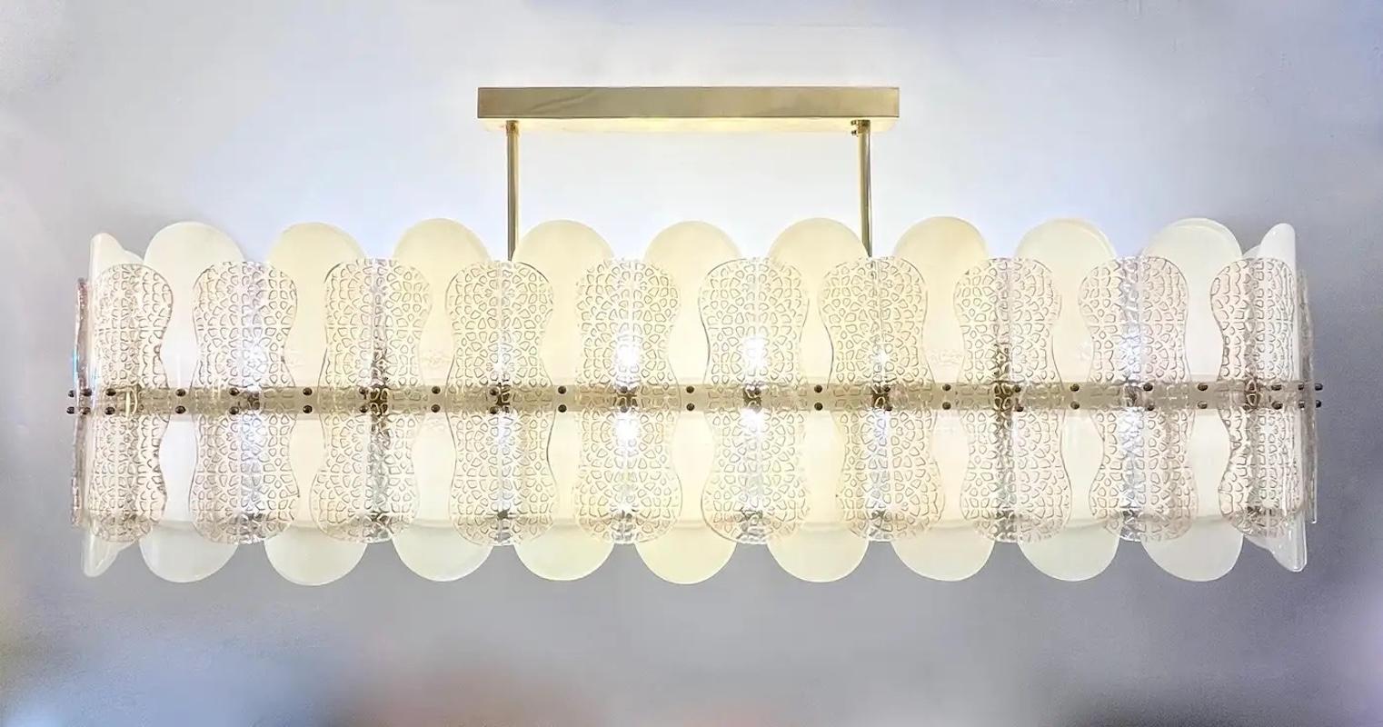 This luxurious, customizable modern chandelier, showcases a sophisticated oval design entirely handcrafted in Italy. Composed of sophisticated elongated oval curved Murano glass geometric elements in a pearl cream ivory color, and features an
