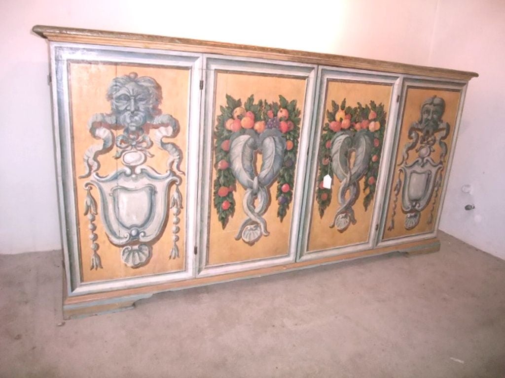 Magnificent Italian credenza with painted doors, could be a master piece for a large entrance or a living room in a mediterranean style mansion .The hard ware are wrought iron. Each painting on each door is an excellent piece of art in the Italian