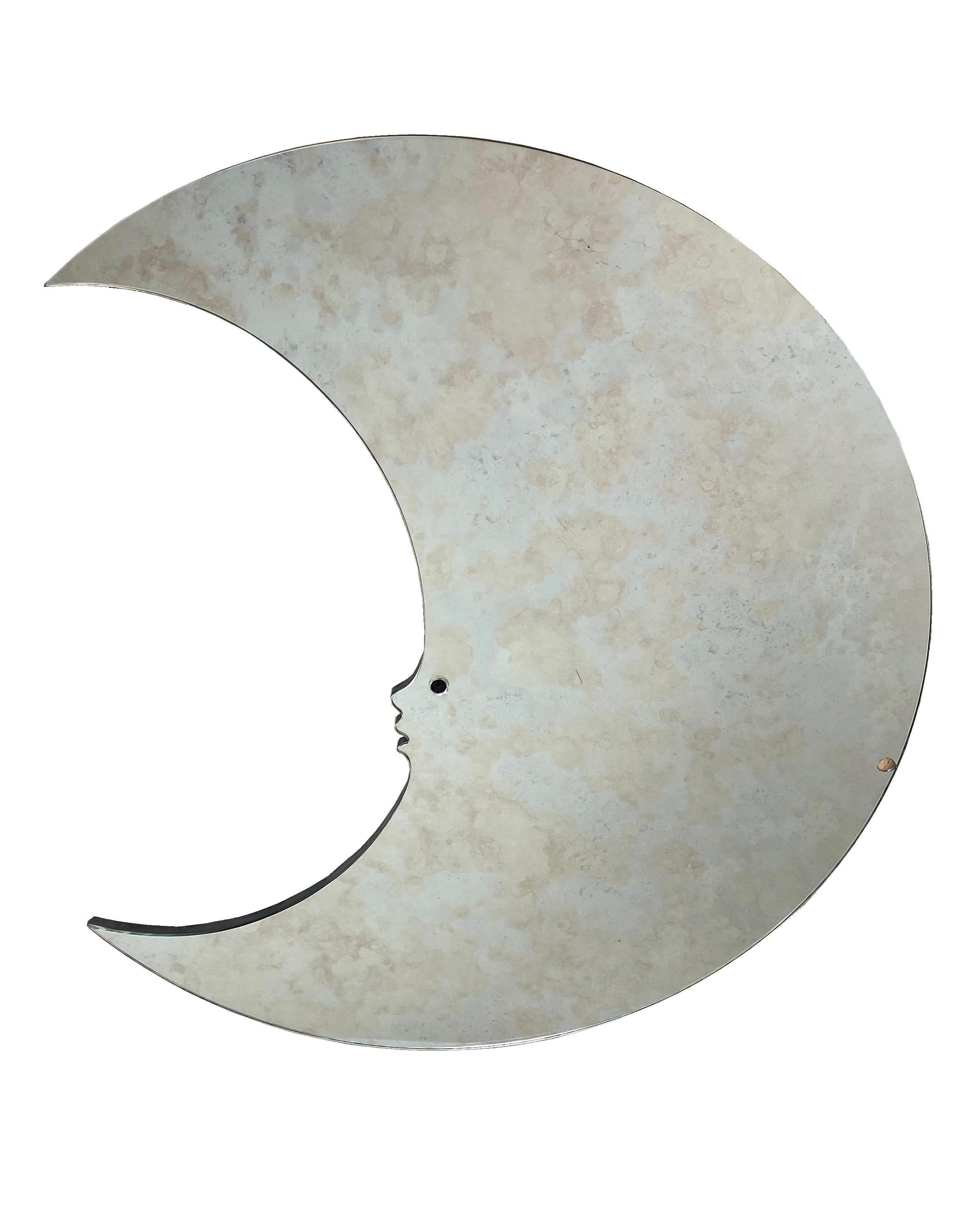 Big wall mirror in the shape of crescent moon with face. A typical example of the Italian design during the 1970s.