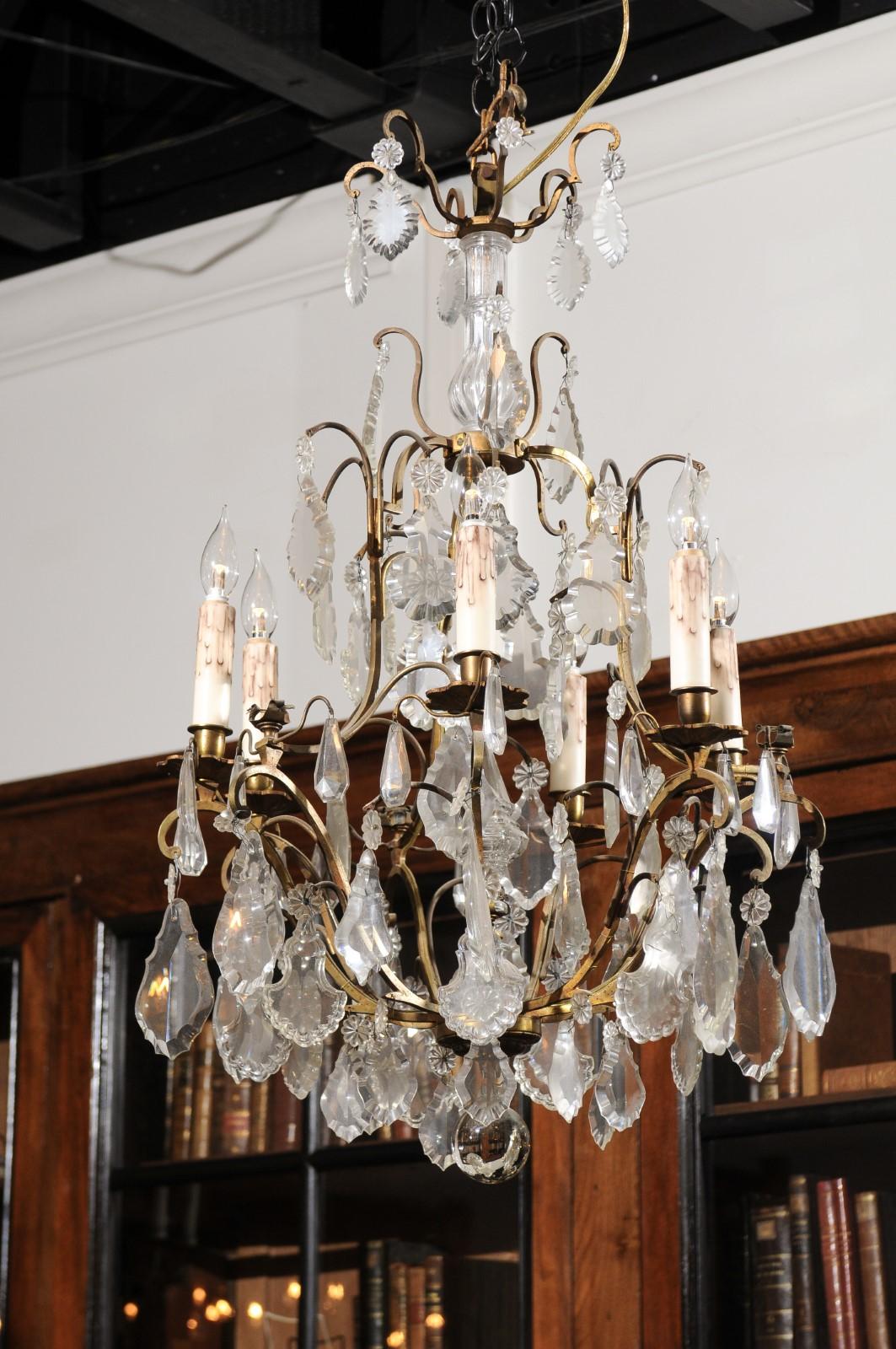 An Italian crystal and bronze six-light chandelier from the mid-19th century, with central obelisk, pendeloques and rosettes. Born in Italy during the third quarter of the 19th century, this elegant chandelier features a bronze armature supporting