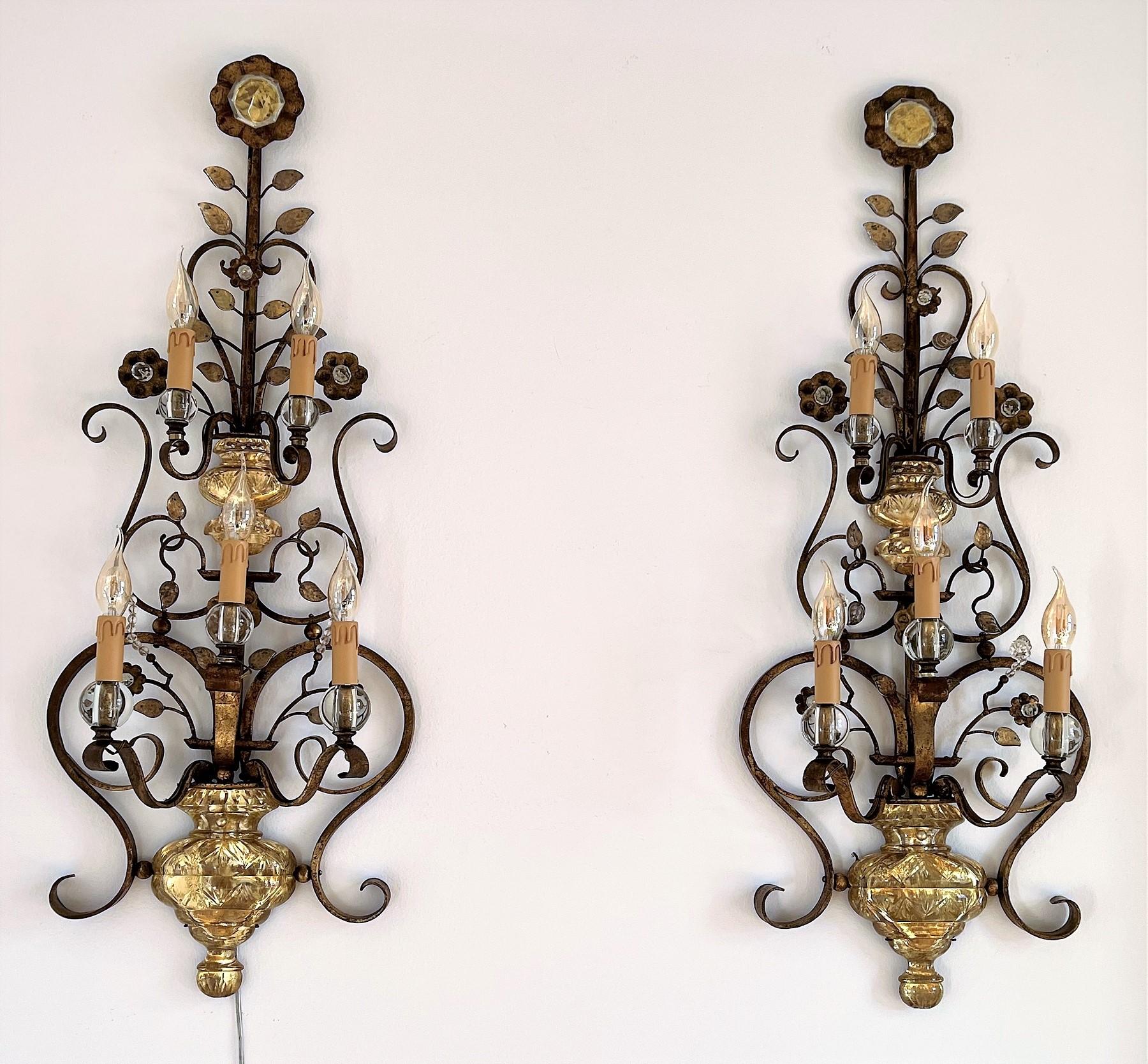 A magnificent pair of extra large rare Florentine wall lights handcrafted expertly in the form of a flower pot with climbing flowers. 
Handcrafted one by one from artisan company Banci of Florence, Italy, in the 1960s. 
The base material is gilt