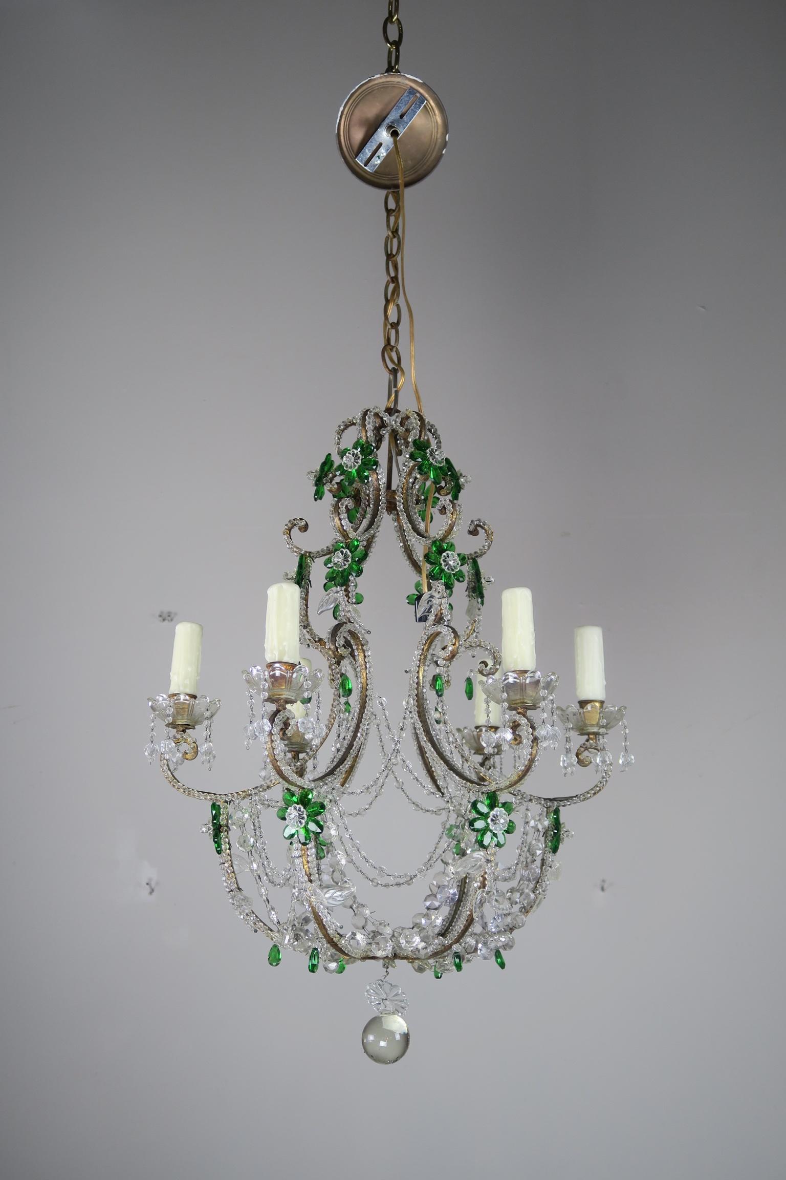 Italian six light Rococo style crystal beaded and gilt metal chandelier with emerald green crystal flowers throughout. The fixture is newly rewired with drip wax candle covers, new chain and canopy included.