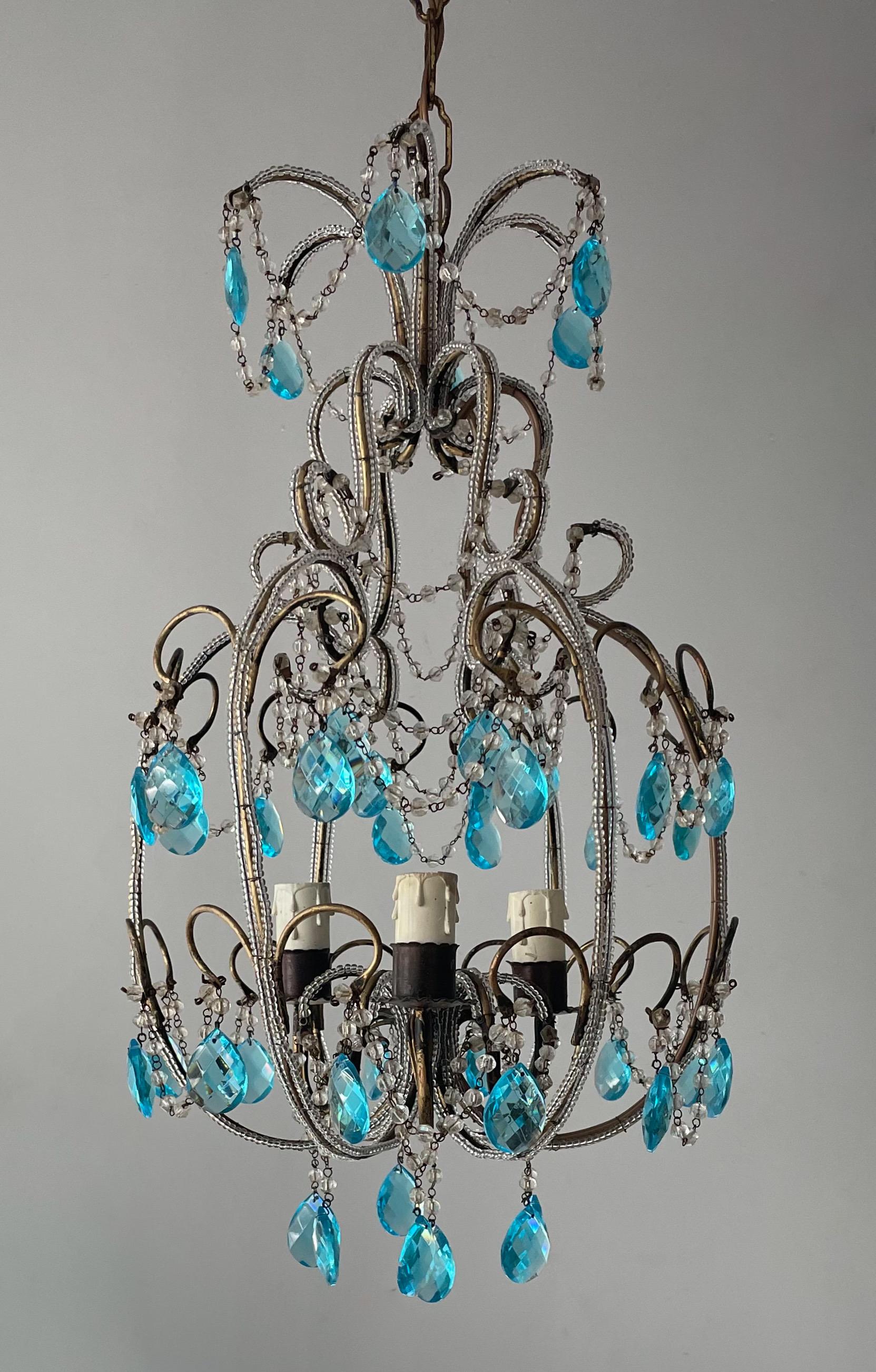 Delicate, vintage Italian gilt-iron and crystal beaded chandelier.

The chandelier features an organic-shaped gilded iron frame outlined with glass beads and faceted turquoise glass prisms. 

The chandelier is wired and in working condition, it