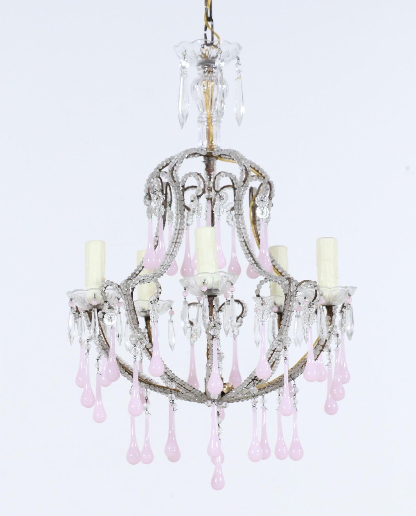 Very pretty, 1950s Italian crystal beaded chandelier with pink opaline glass drops. 

The chandelier consists of a shapely iron frame with a naturally-distressed gilt finish and original “English cut” beading on the arms. The pink opaline drops add