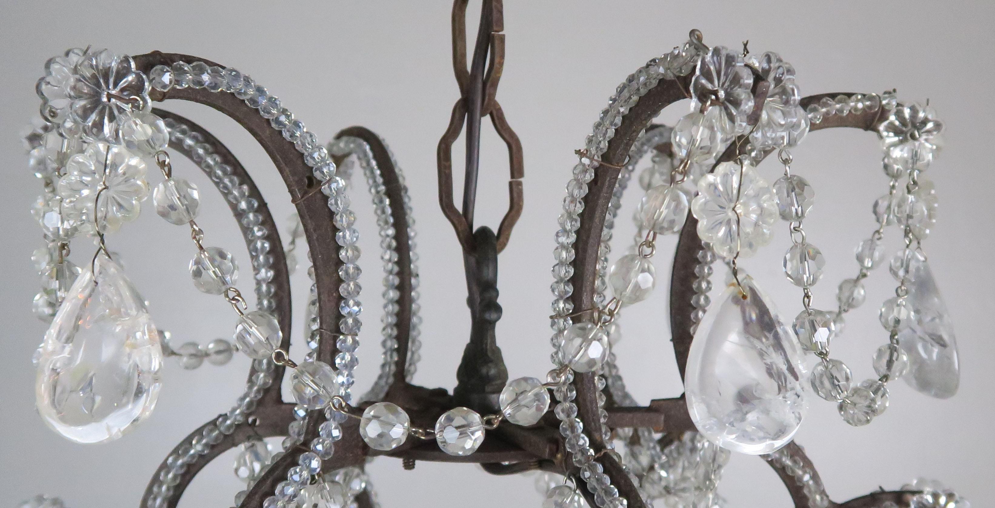 Vintage Italian crystal beaded arm chandelier with garlands of cut beads and almond shaped rock crystals throughout. The fixture is newly rewired with cream candle covers. Includes chain and canopy ready to install.