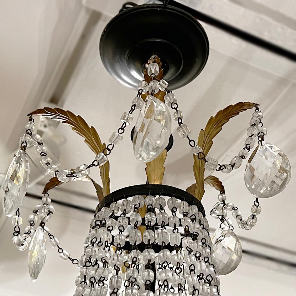 A circa 1920's Italian wrought iron chandelier with crystal beads.

Measurements:
Height: 38