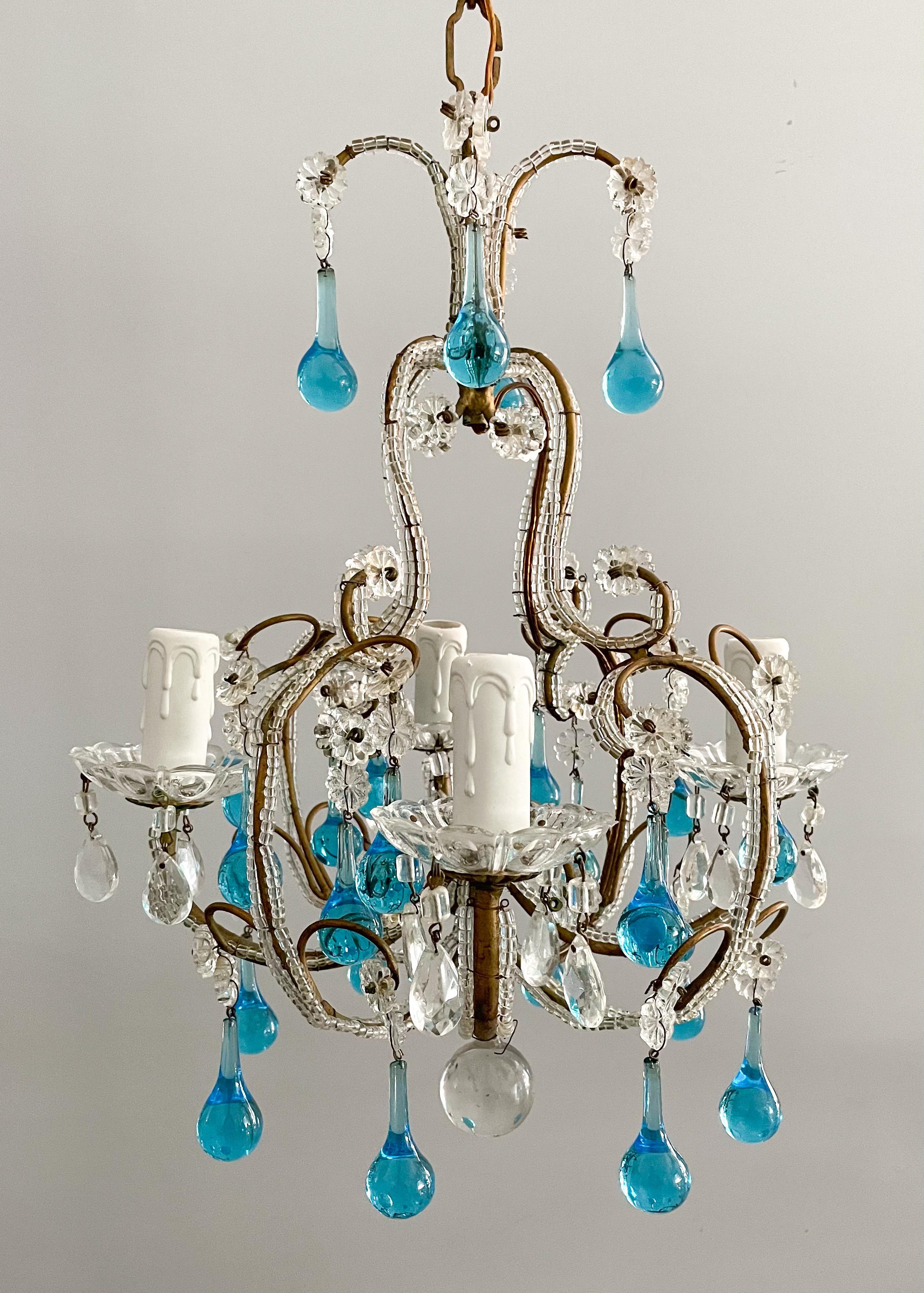 Beautiful, vintage Italian crystal beaded chandelier with Murano glass drops.

The chandelier consists of a small-scale gilded iron frame outlined with tiny glass beads and decorated with turquoise glass ball drops. 

The chandelier is wired and