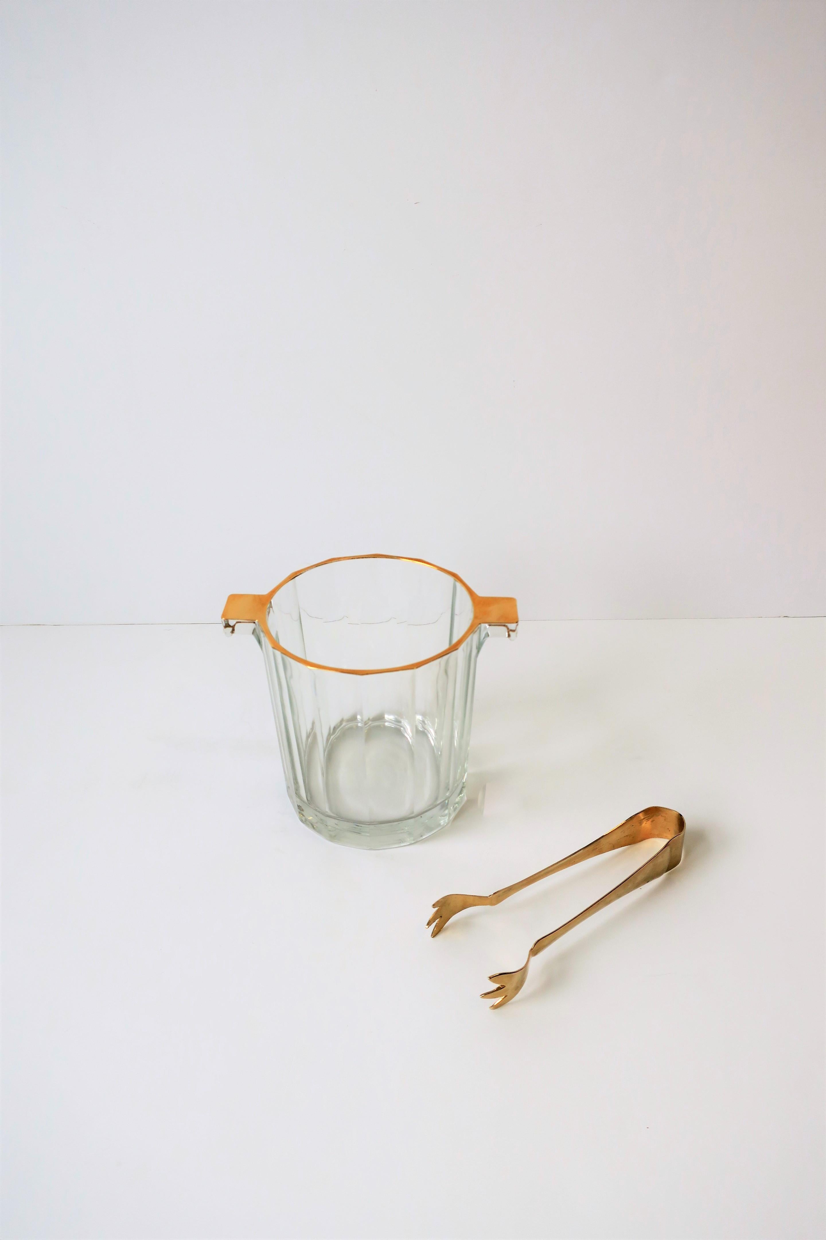 A beautifully made Italian crystal ice bucket with gold-tone tongs, in the Hollywood Regency style, circa 20th Century, Italy. Piece is well preserved as an 'ice' bucket with tongs to grab ice cubes as show in images. Piece can alternatively serve