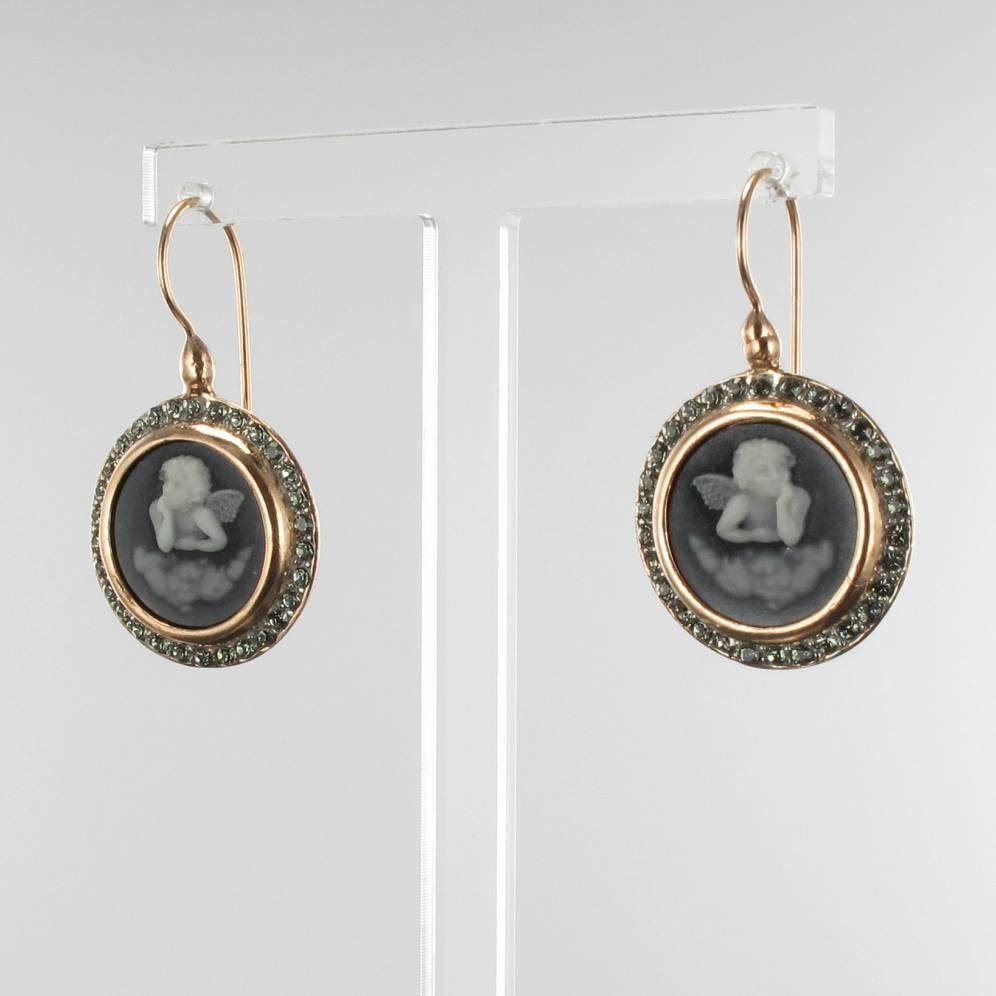 For pierced ears.
Pair of earrings in vermeil, silver and rose gold.
Drop earrings are set by glass cameo and crystals. The clasps are goosenecks with safety hooks. 
Total weight : 9,7 g approximately.
Overall length: 3.7 cm, total width: 2.2 cm,