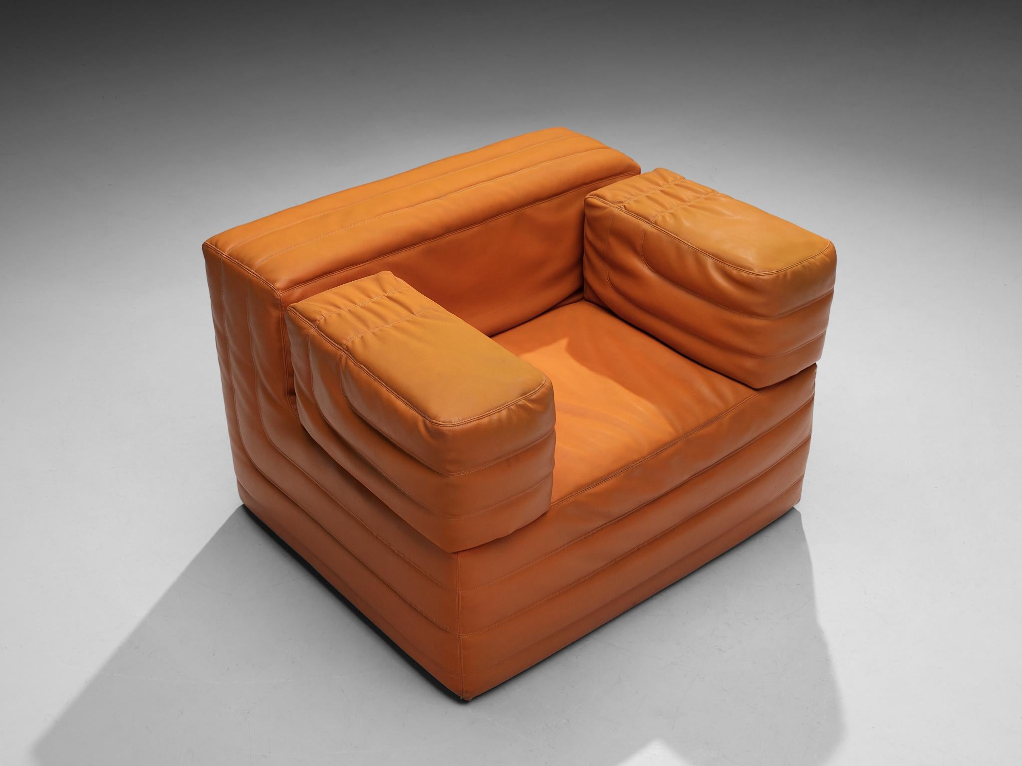 Lounge chair, leatherette, Italy, 1970s

This striking lounge chair comes with an eye-catching orange colored faux leather upholstery that gives the room a vibrant and lively touch. The design is further characterized by geometrical sharp lines