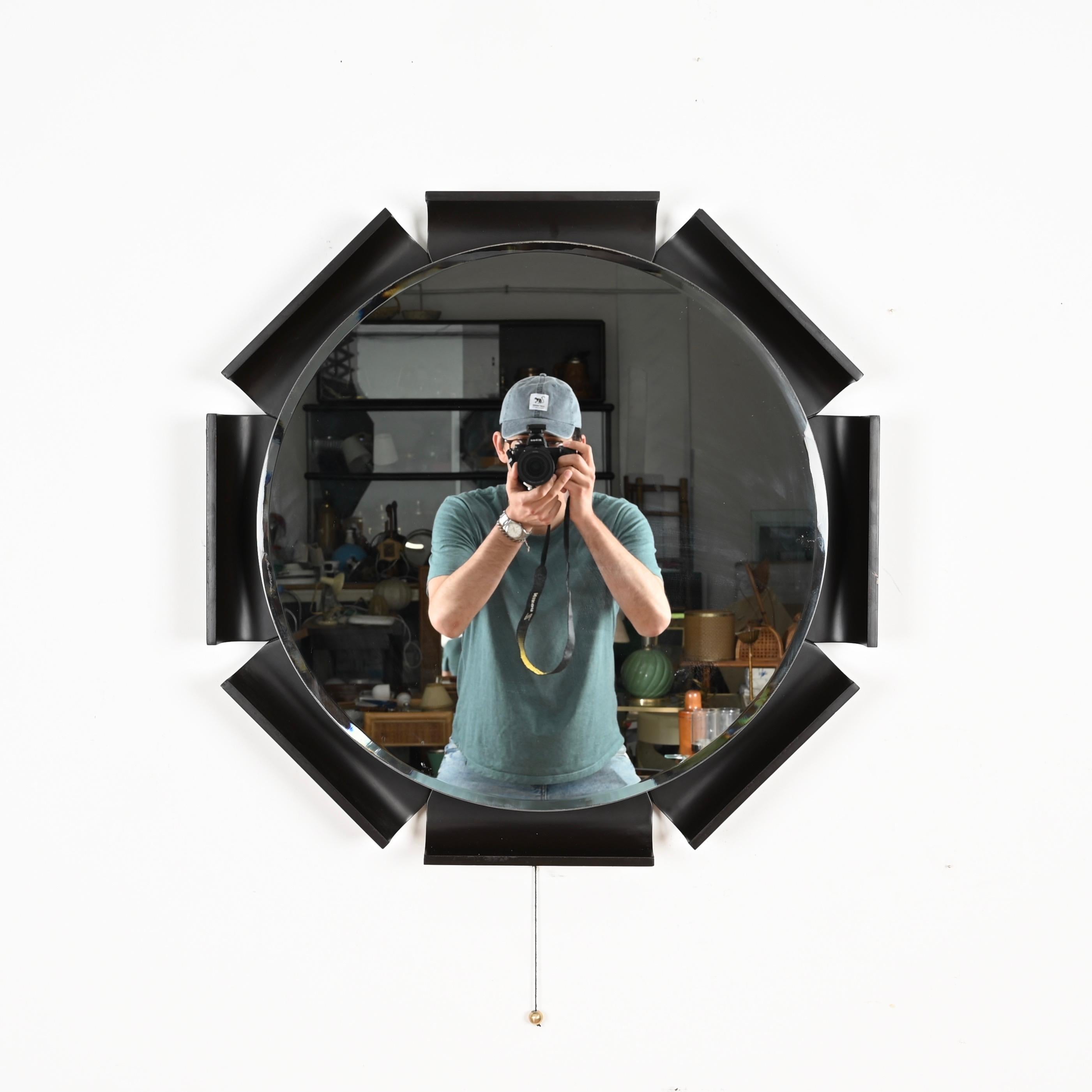 Spectacular and incredibly rare backlit mirror in curved lacquered black teak with a central beveled mirror designed by Ico Parisi and produced by ISA Bergamo in Italy in 1968.  

In amazing condition. The outstanding quality of the wood used and