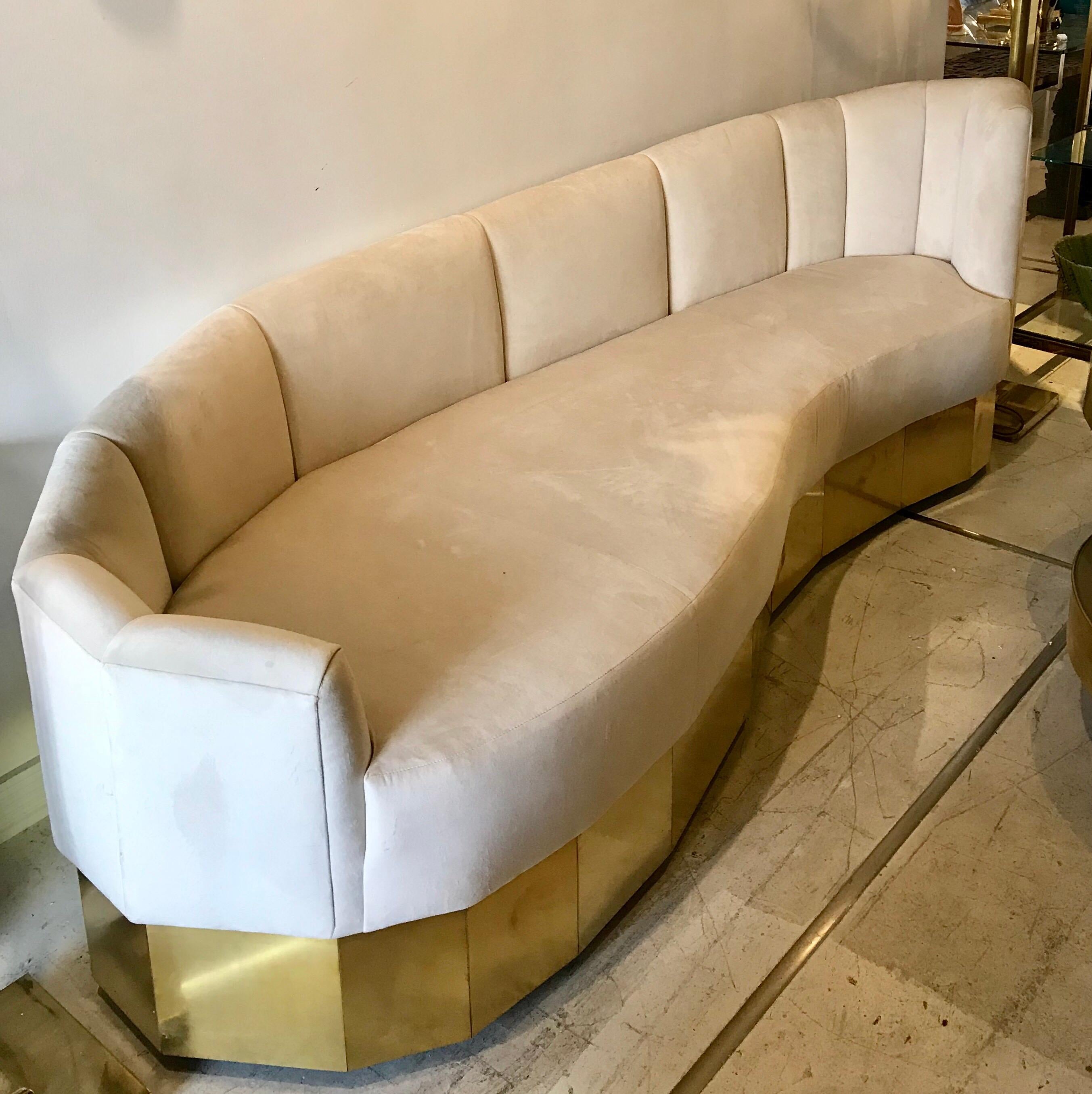 Gorgeous sculptural Italian cream colored velvet and brass curved sofa.