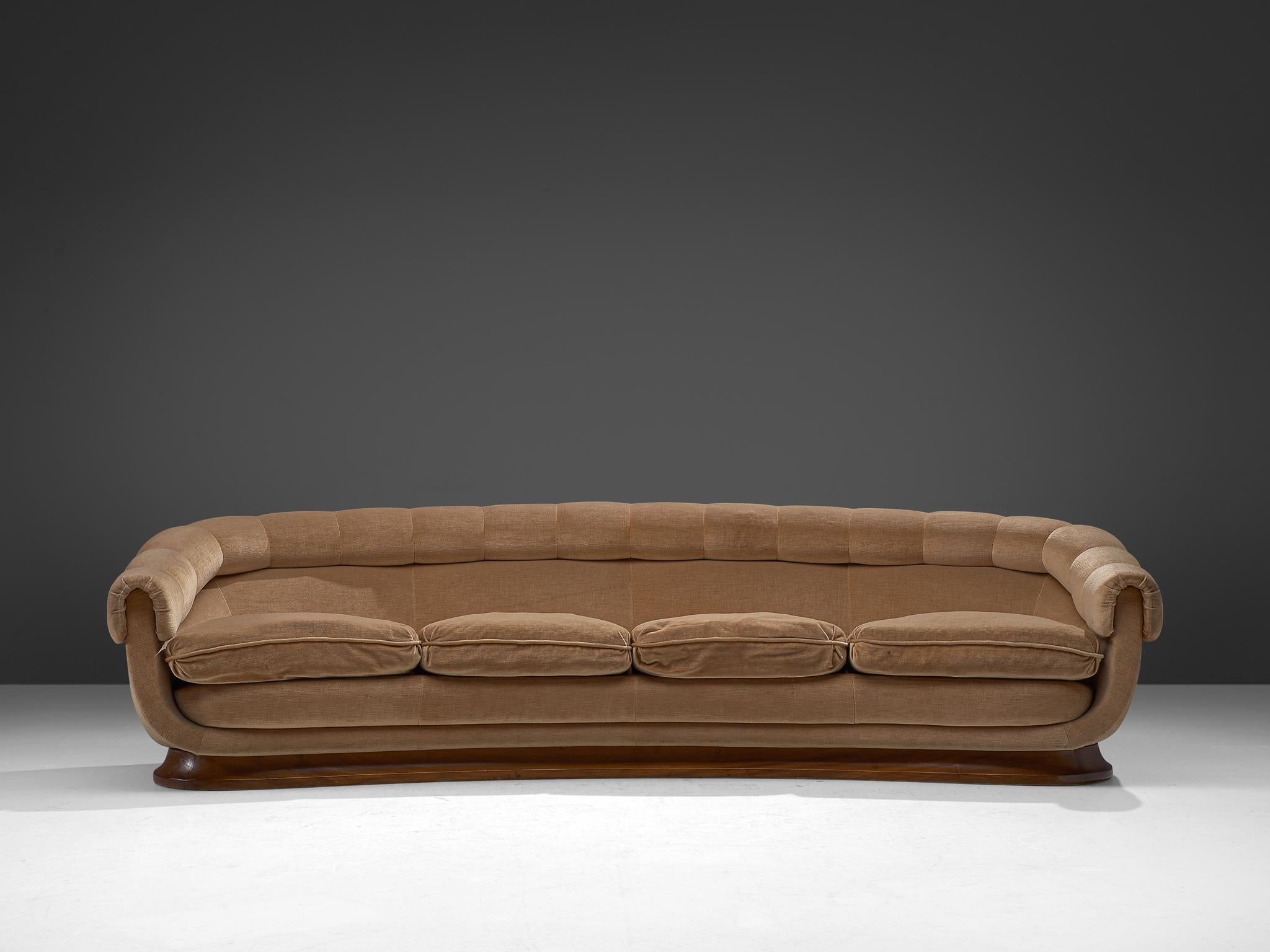 Italian four-seat sofa, fabric and wood, Italy, 1950s

An Italian voluptuous and bold sofa that shows a play of volumes with soft, fluid and rounded lines. The large sofa features a thick and rounded backrest that ascended flows over to the