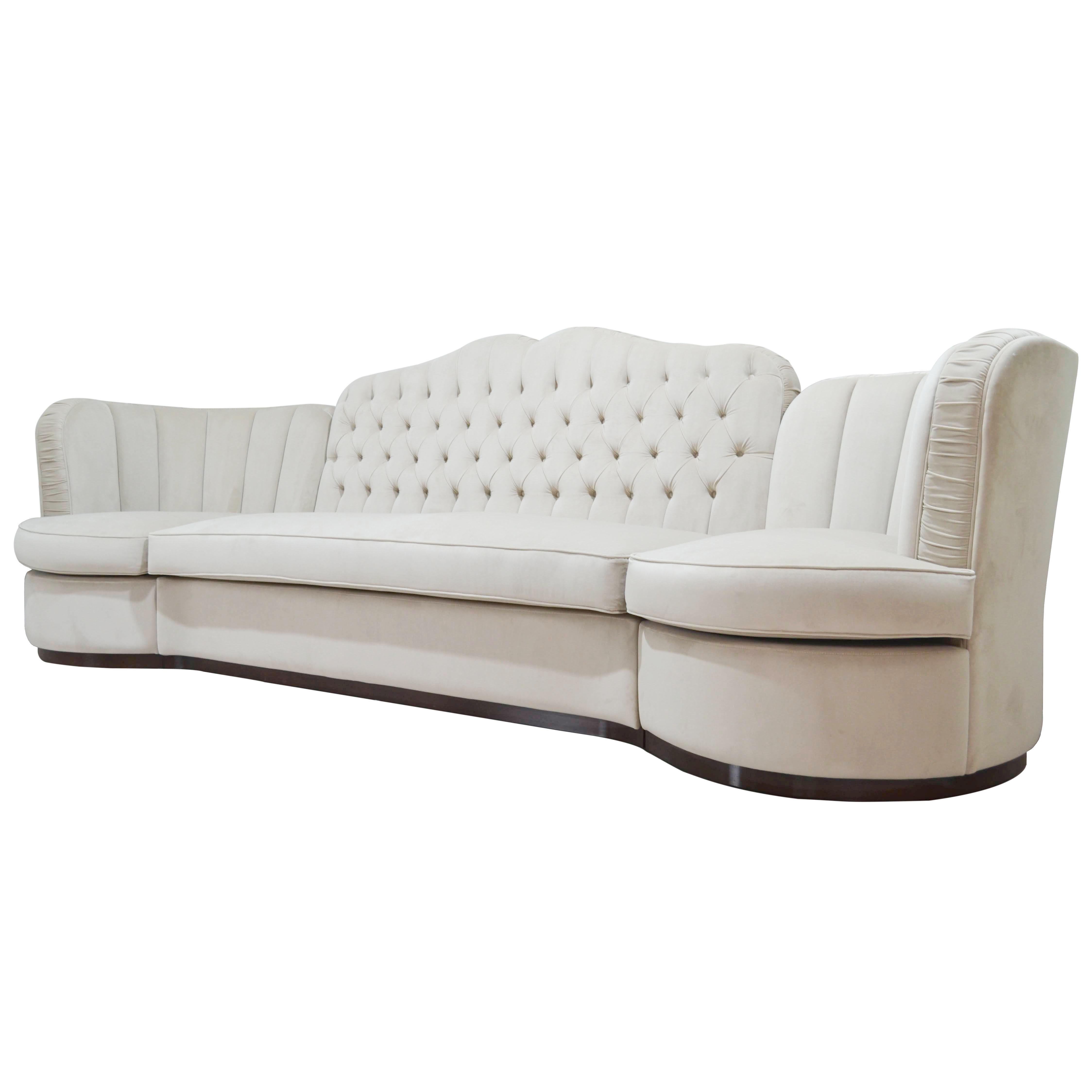 This gorgeous and large scale modernist sofa was handcrafted by artisans in Italy, by Cavio Casa, based off a classic design. Spanning over eight feet in length, this beautiful sofa offers elegant proportions and sweeping dramatic curves throughout