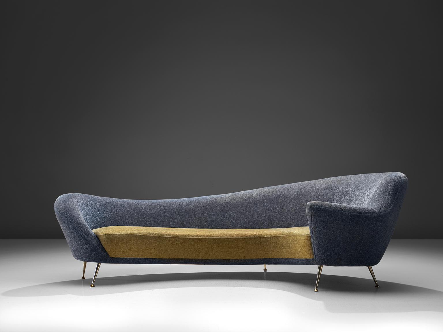 Curved sofa, yellow and blue fabric, brass, Italy, 1950s.

Dynamic sofa with an a-symmetrical back. The back of the sofa is higher on the right side and slowly slopes towards much lower end on the left side. The seating is designed as shells that