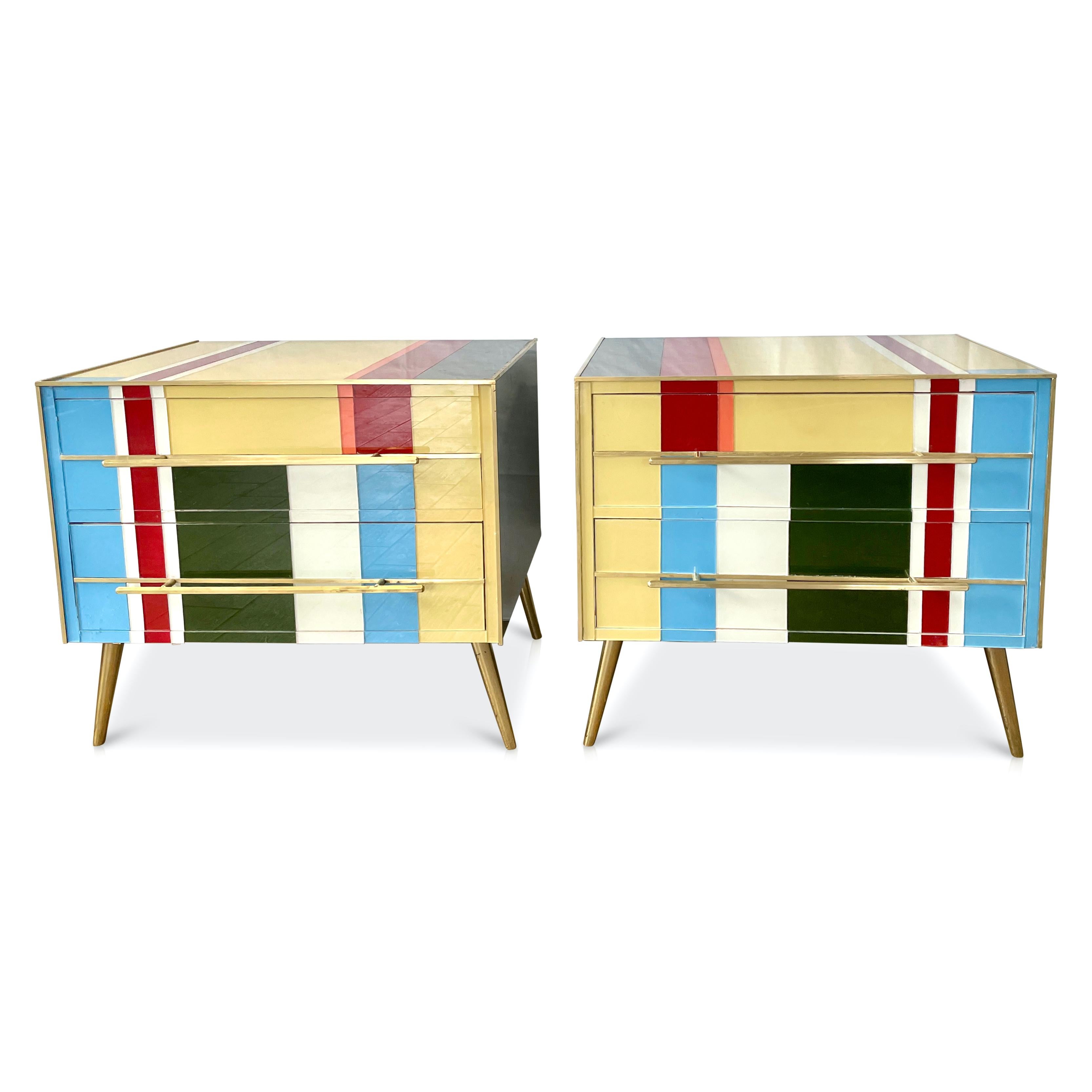 Contemporary customizable modern graphic pair of geometric Pop design two-drawer side tables / nightstands, entirely handcrafted in wood with a Piet Mondrian inspired abstract decor, the surrounds edged in brass are in colored glass: aquamarine
