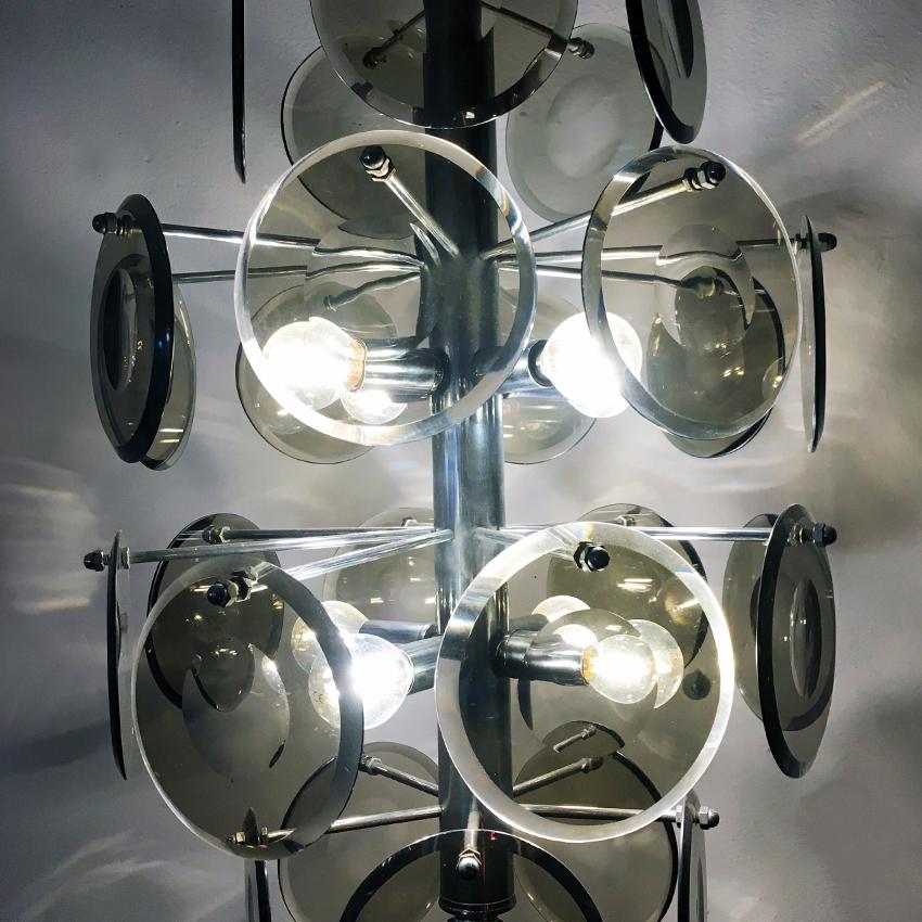 Italian cut fumé crystal and steel ceiling lamp, 1970s. 
Eight lights chandelier, with chromed steel structure and pendants in the shape of a disc in smoked cut crystal.