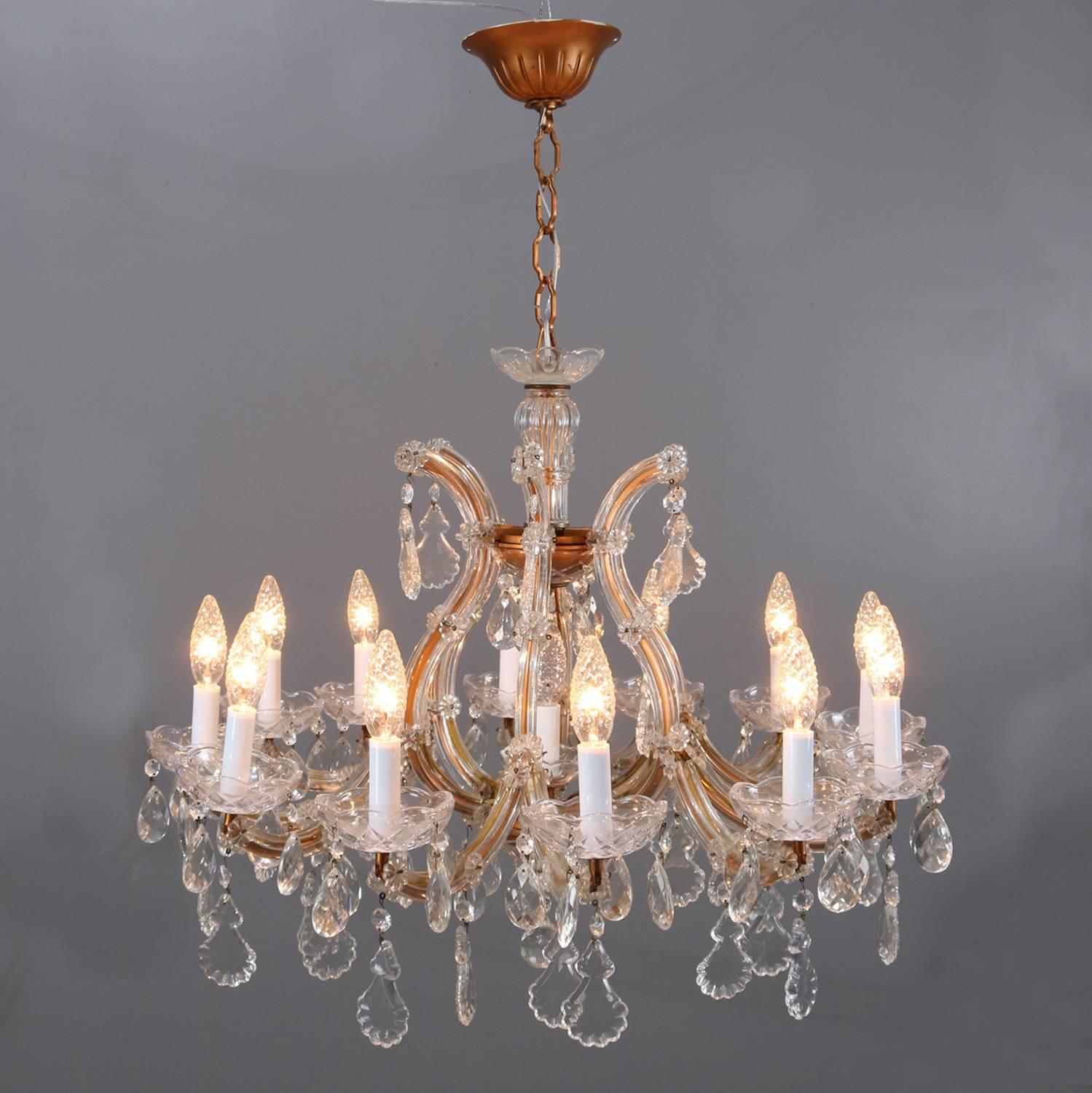 Italian traditional twelve-light Prague chandelier features scroll form with glass arm and hanging cut rock crystal trimmings throughout, newly re-wired, circa 1930

Measures: 22