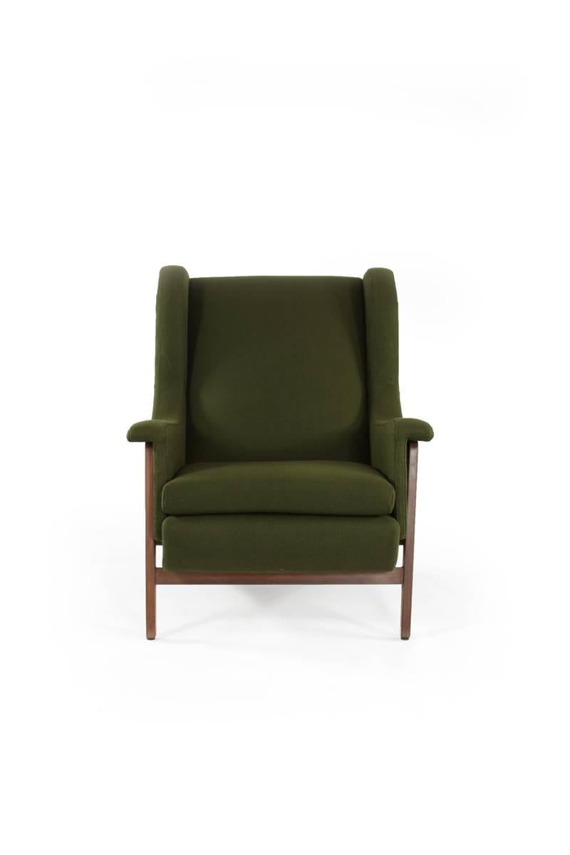 Italian wingchair in the style of Gianfranco Frattini. The rustic frame, upholstered in dark olive green, is supported by legs crafted from wood. Upholstered with vintage fabric.

         