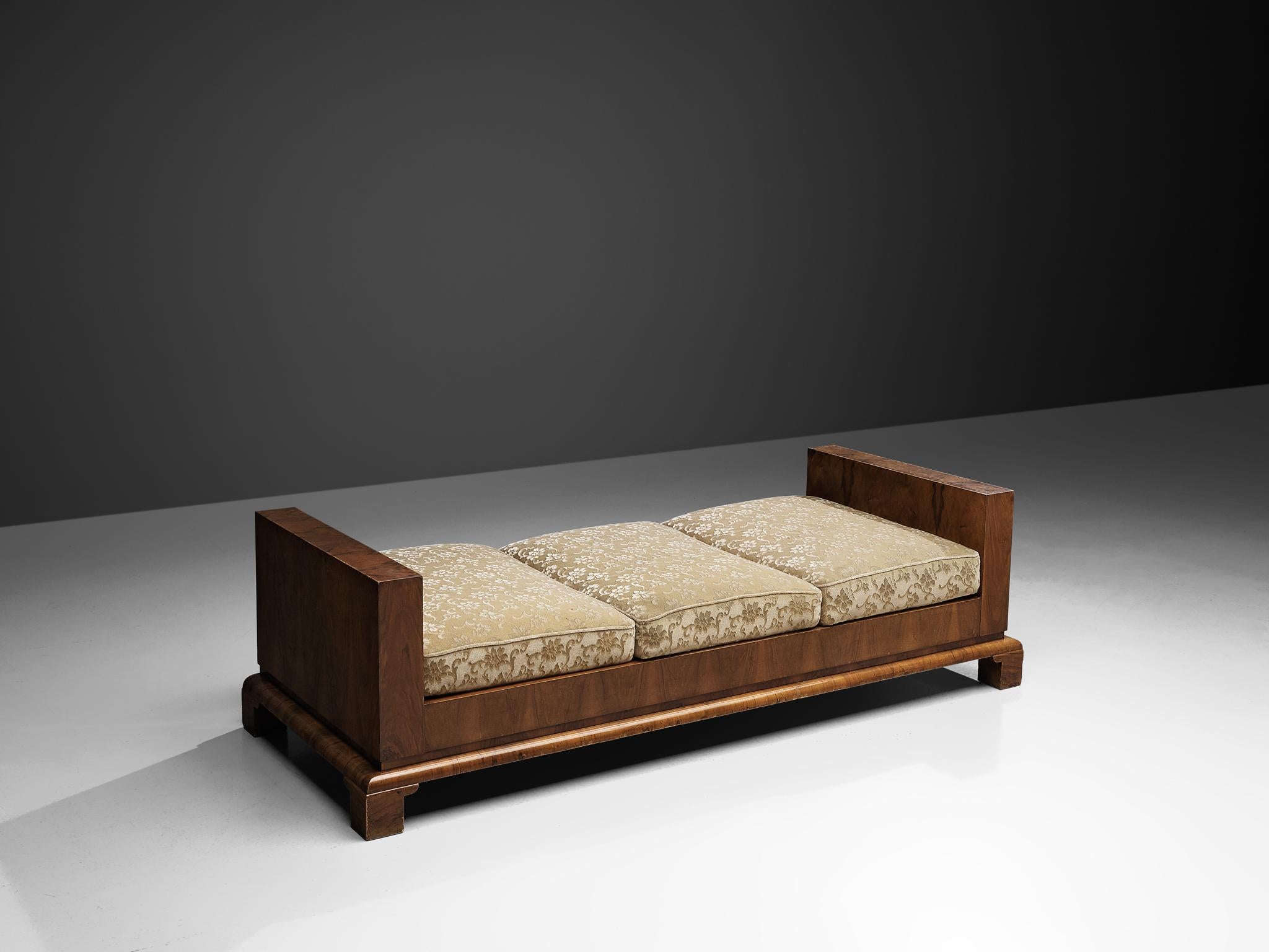 Daybed, walnut and fabric, Italy, 1930s

An Art Deco sofa-bed, featuring a sturdy, masculine walnut veneered frame. The legs are short and form a balanced whole with the stately, robust lines of the daybed. The cushions can be arranged on the side
