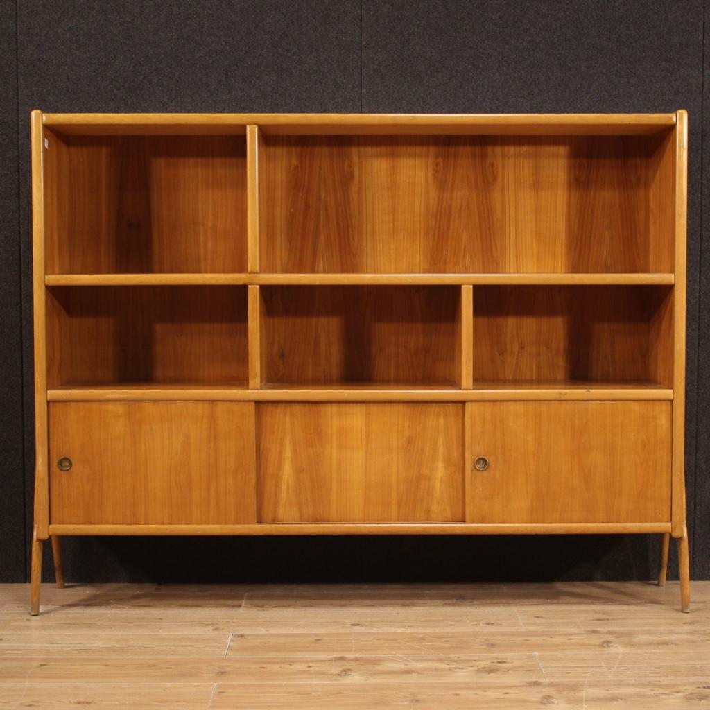 A beautiful Italian design bookcase in exotic wood.

Italian design bookcase from the 60s / 70s. Furniture in light exotic wood nicely carved and built in a single non-divisible block. Open bookcase with 5 compartments in the upper part and two