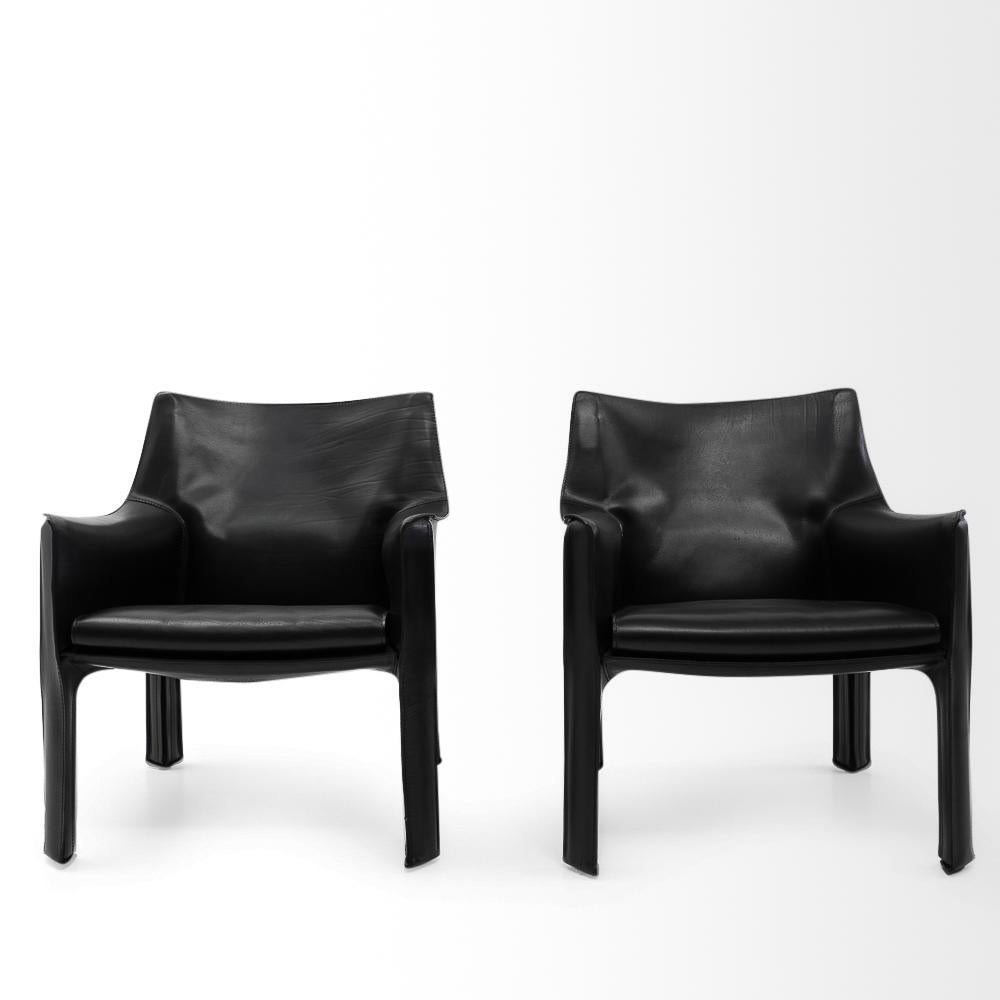 Set of two Cab 414 armchairs in black leather by Mario Bellini for Cassina.

These very comfortable lounge chairs are built up with a tubular steel frame over which foam and thick saddle leather is fitted. The leather skin is kept in place with