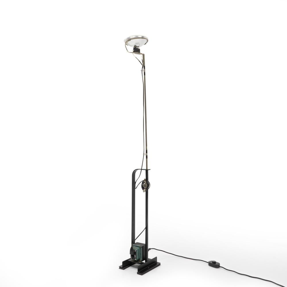 Height adjustable floor lamp designed by Achille & Pier Giacomo Castiglioni for Flos during the early 1960s.

The barebone industrial style was an experimental design, contrasting the sleek and clean lines that was often exhibited in the furniture