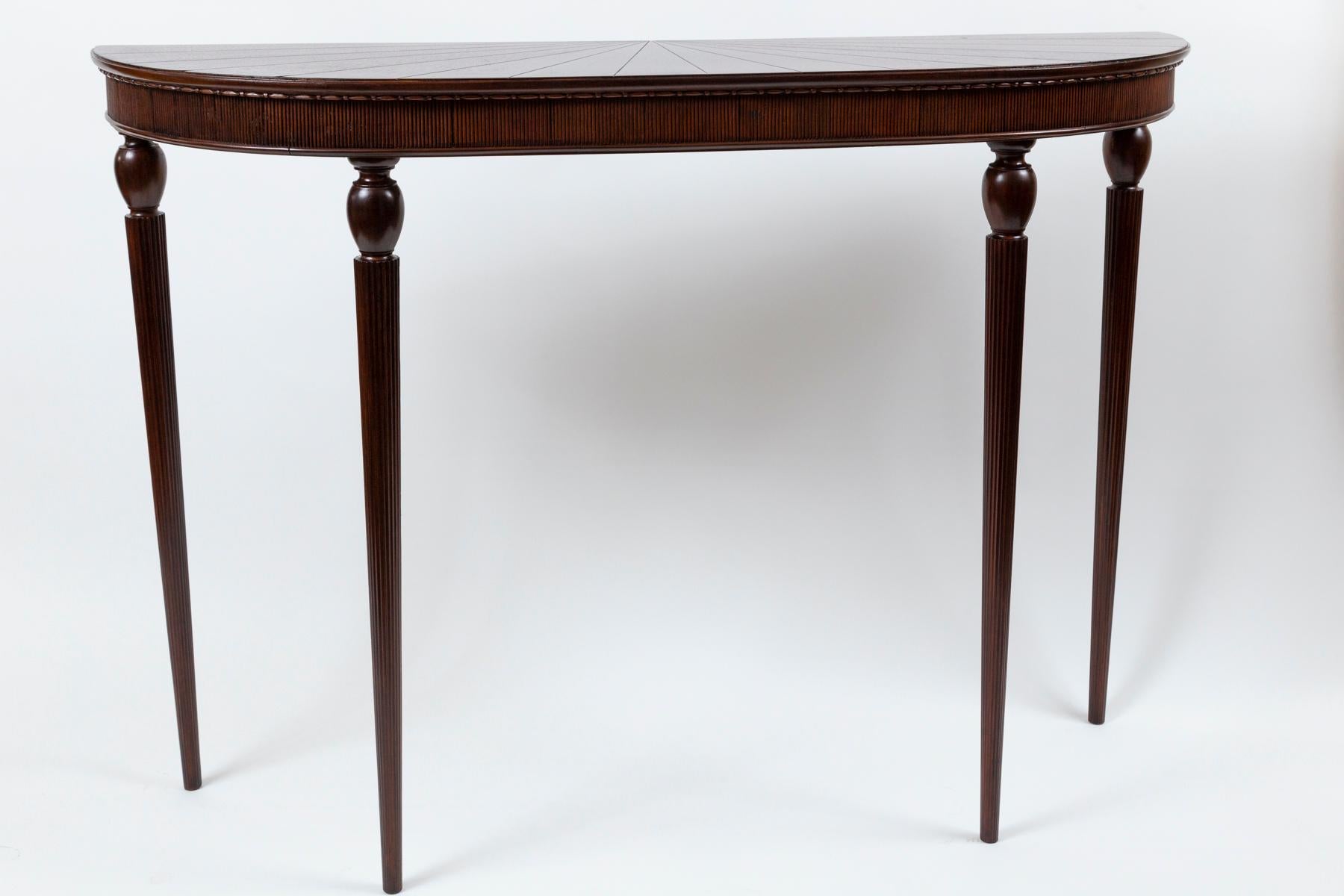 Elegantly proportioned Italian walnut d-shaped console with reeded apron finishing on four high turned and reeded legs.
Attributed to Paolo Buffa’s earlier pieces where he modifies classical forms with his modern sense of scale 
Origin: