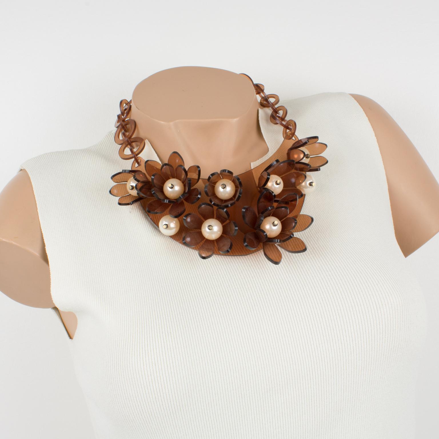 This striking transparent copper Lucite or Plexiglass bib choker necklace was crafted by Italian designer Manoa2 (Milano 1980 - 1985). A collar shape with a large curved bib topped with dimensional flowers and huge pearl-like beads. Note that the