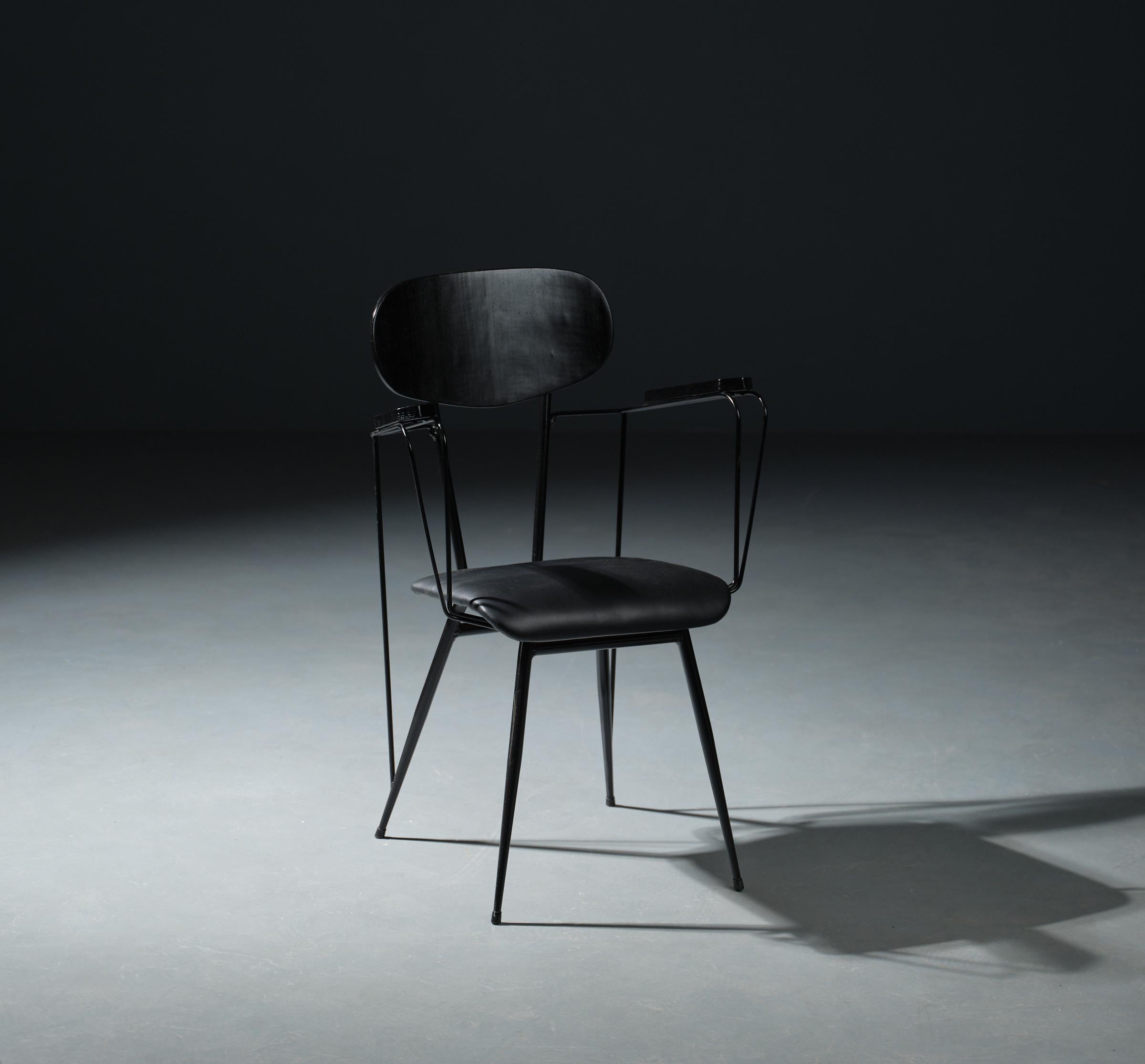 Introducing a rare find from the 1950s, this desk chair embodies iconic Italian design. Crafted with a black lacquered iron frame and tapered legs featuring a unique compass opening, it exudes elegance and sophistication. The seat and backrest are