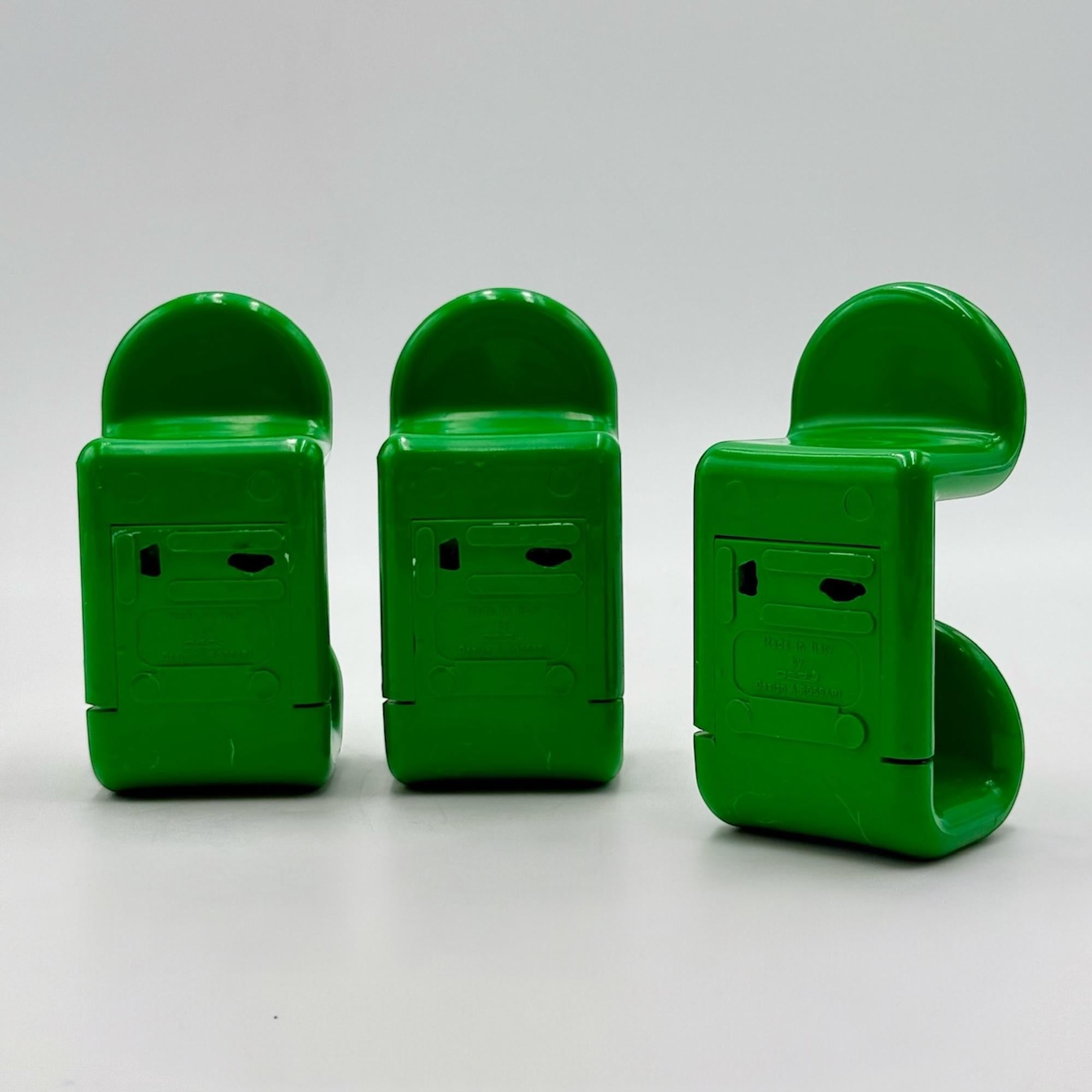 Bring the essence of the Seventies into your space with this beautiful set of 70s coat hooks designed by Ambrogio Rossari for Gedy. Crafted in Italy, these hooks feature a vibrant green plastic construction and a minimalist yet sinuous design that