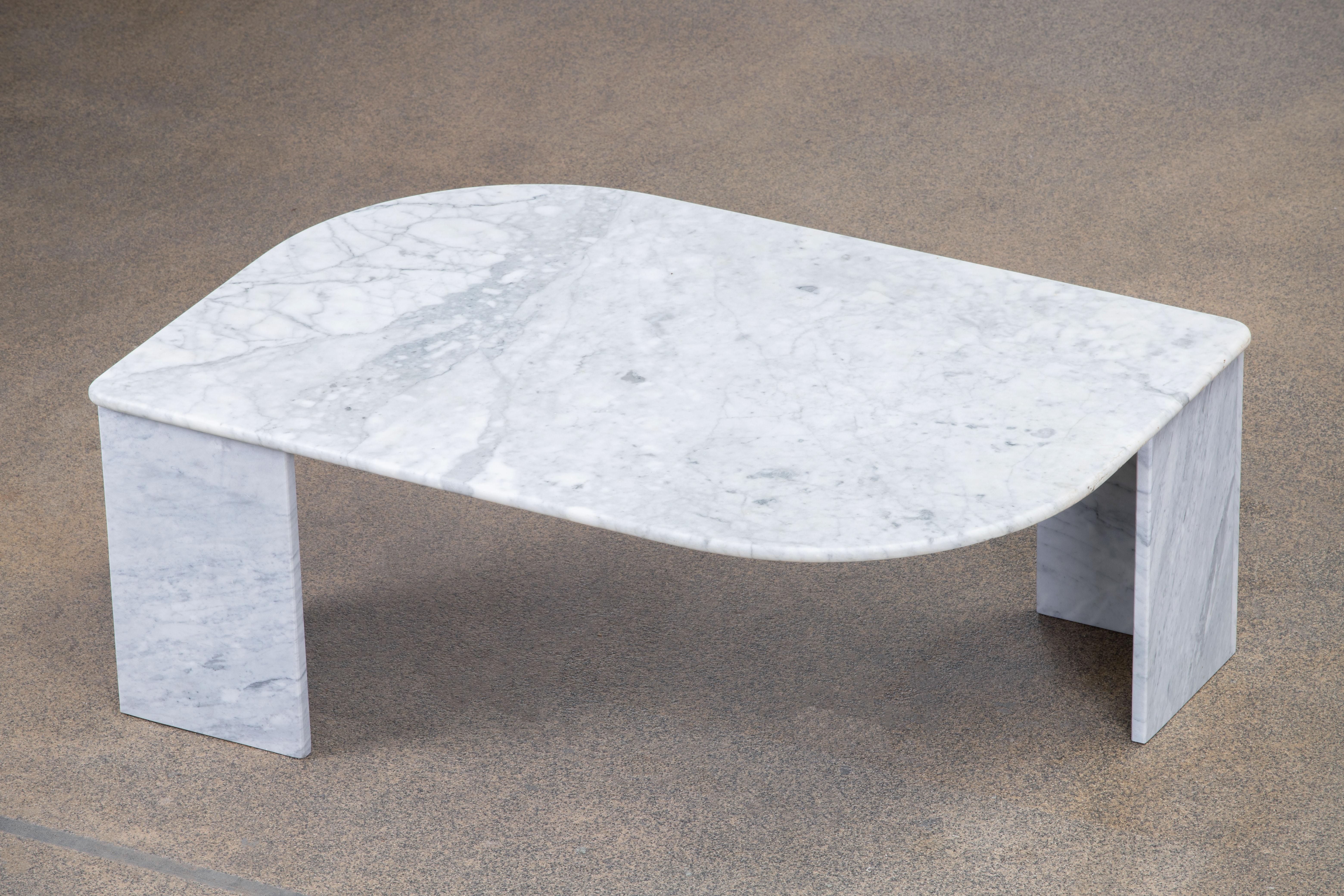 Beautiful grey and white marble table.

The heavy eye-shaped top rests on two marble V blocks.