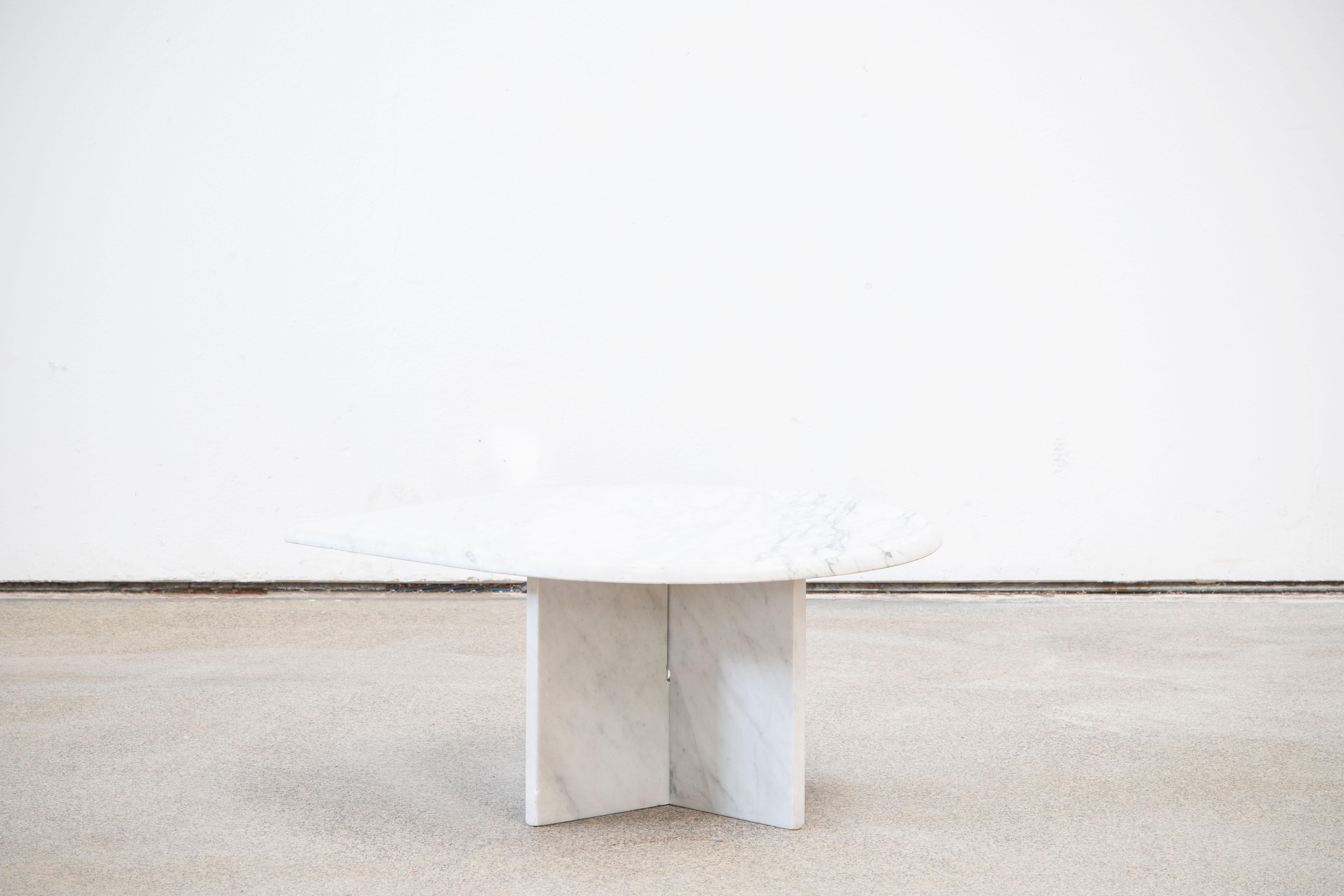 Beautiful grey and white marble table.

The heavy eye-shaped top rests on two marble V blocks.
