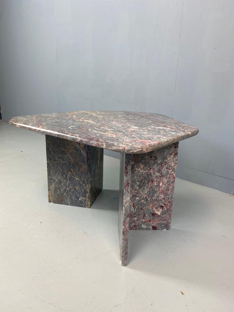 Beautiful hand crafted coffee or side table made of veined gray marble. The table consists of 2 separate table legs and a table top. The organic formed table top is loose on the table legs, but the weight of the marble makes it very stable. 

The
