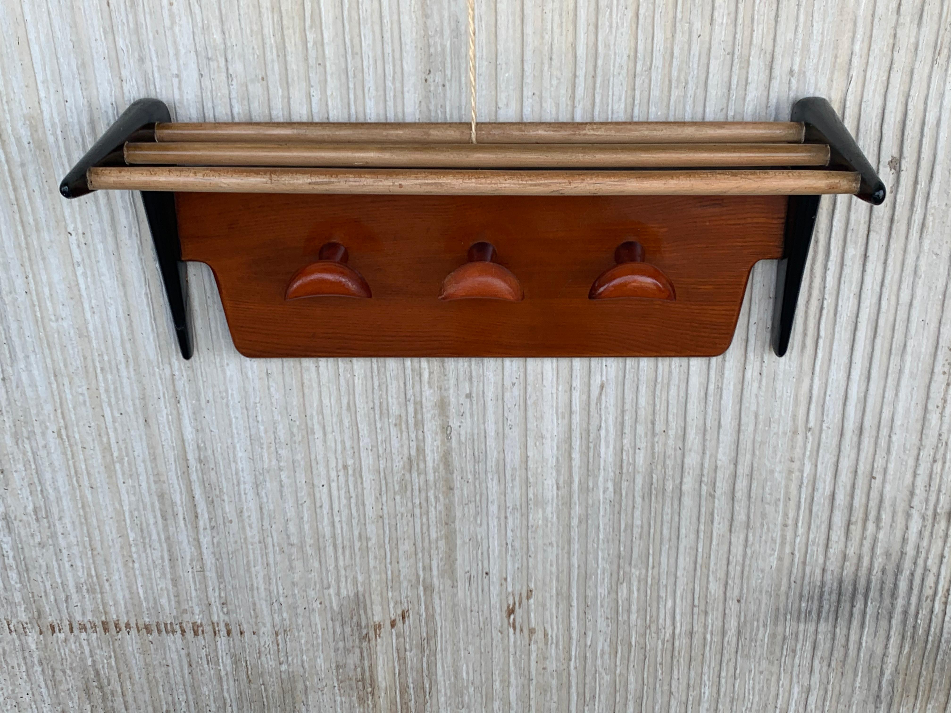 Wonderful design and color, Mid-Century Modern entry hall coat rack. This beautifully designed, perfectly executed and highly practical midcentury coat rack could be the ideal piece to come home to. Thanks to the integrated metal hooks on the back