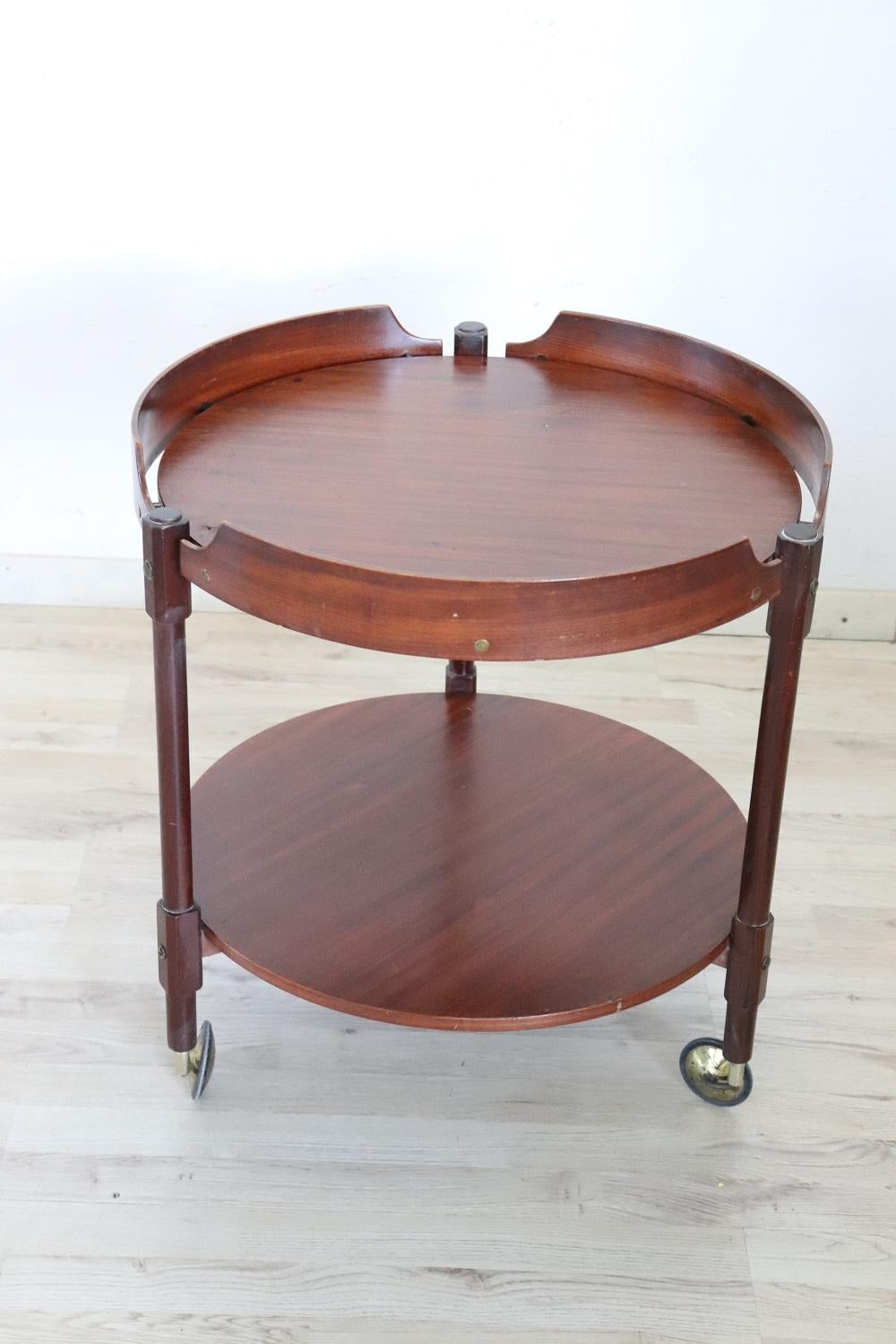 Rare 1950s Italian desgin serving bar cart. Made of teak wood equipped with two shelves and brass wheels for convenient movement. Perfect for serving drinks to your guests.