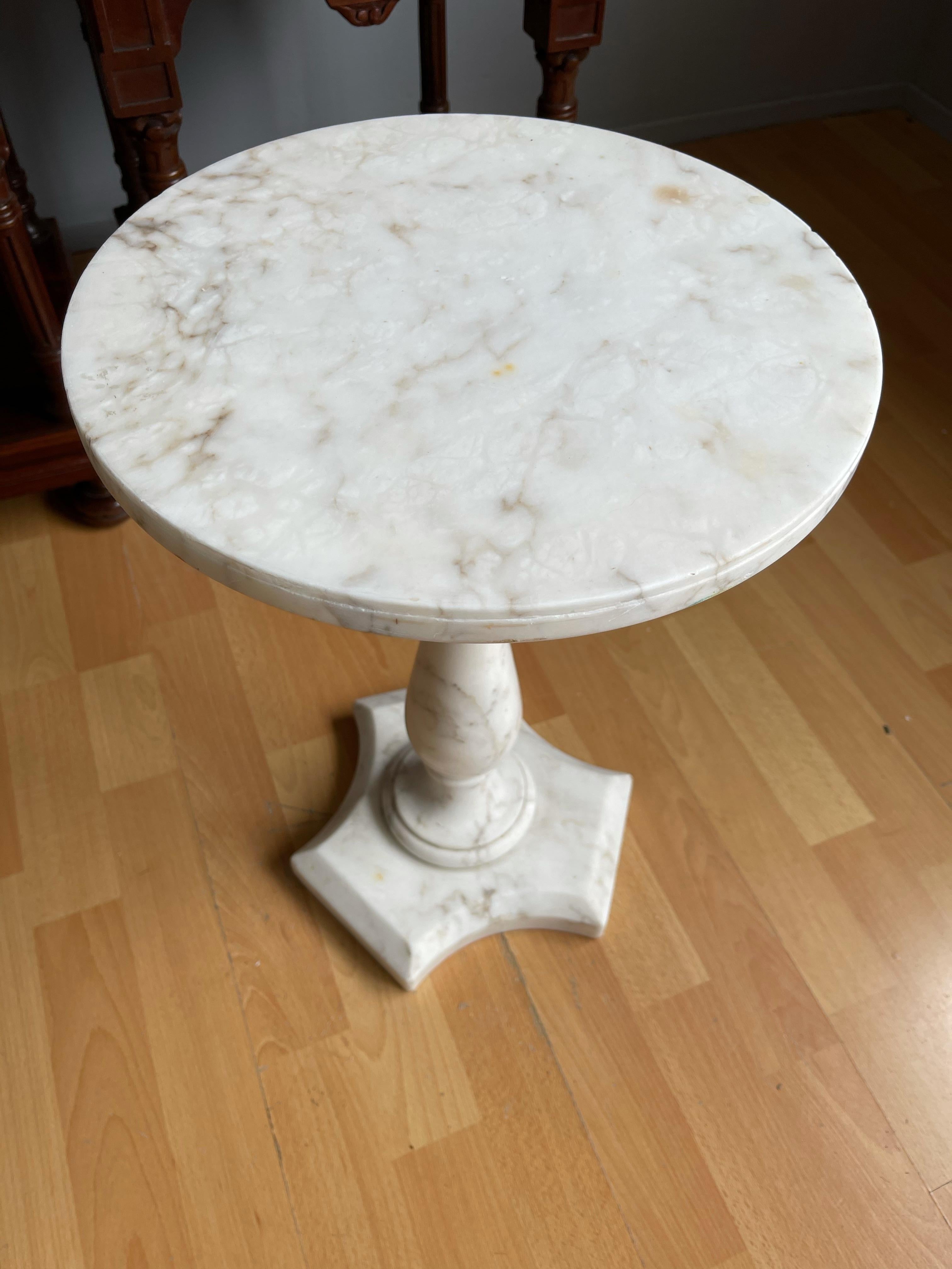 Beautiful and practical, handcrafted table.

This rare and beautifully shaped flower stand is entirely hand-crafted out of a beautiful white marble. This timeless table is in good to excellent condition and we date it from the 1960's. This fine